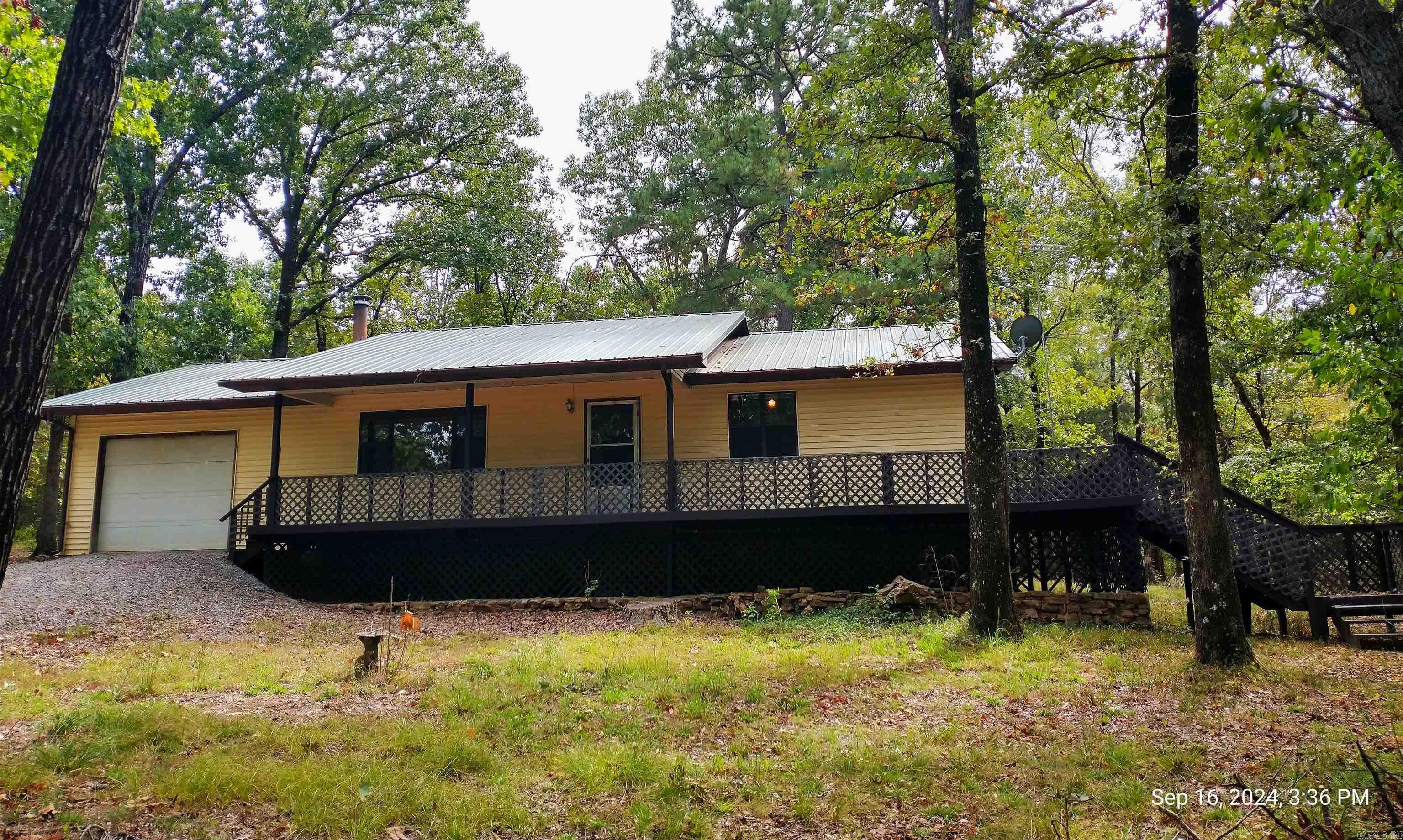 This 2 BR 2 BA Home on 5.74 Acres M/L, is located in the Flat Rock Area and, Close to Piney Bay on 3 Wooded Lots in Eagles Nest Subdivision. With a Formal Dining & Large Utility Room, You Could Have a 3rd Bedroom. Owner has freshened up with New Interior Paint, Newer Metal Roof, 2 Solar Powered Attic Vent Fans, Etc. This Home also has a Large Wrap Around Porch and a 1 Car Garage.