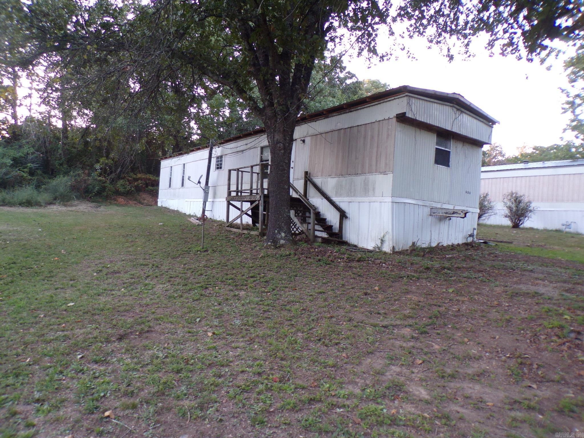 WORK IN PROGRESS on this mobile home in Mountain View, AR. 2 bedroom, 2 bath home with open living room/dining/kitchen area. Front and back porches. New vinyl flooring throughout. Close to the court square where people meet together to pick and play music. Enjoy sitting on the back porch swing and grilling out with your family. Good opportunity to finish remodeling and have a rental or live in. Owner is listing at this price until more work is done. $49,000.00.