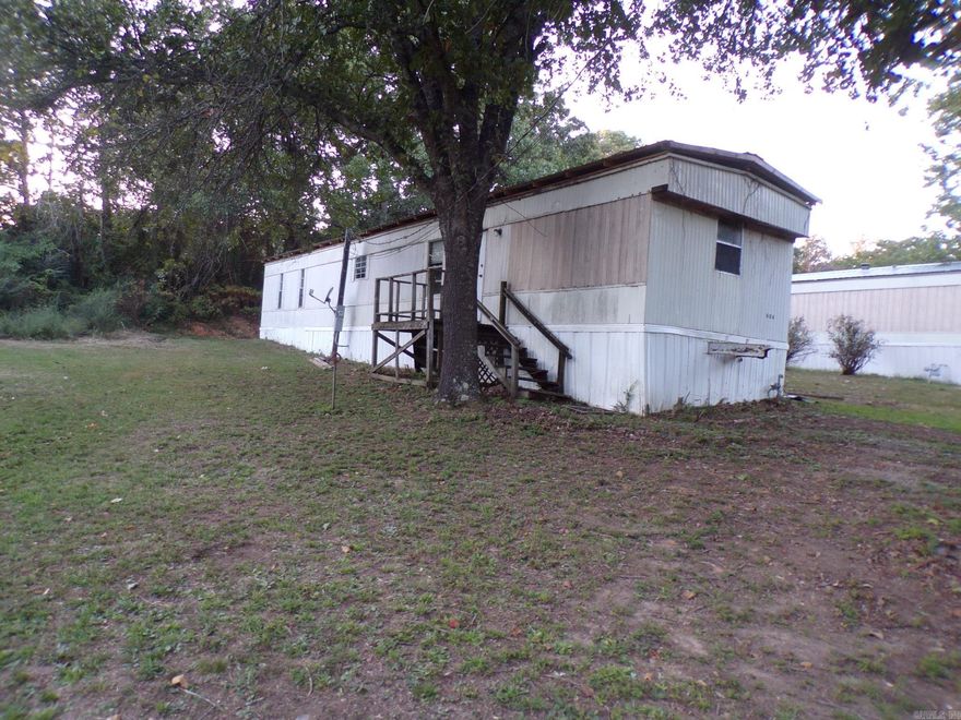WORK IN PROGRESS on this mobile home in Mountain View, AR.  2 bedroom, 2 bath home with open living room/dining/kitchen area.  Front and back porches.  New vinyl flooring throughout.  Close to the court square where people meet together to pick and play music.  Enjoy sitting on the back porch swing and grilling out with your family.  Good opportunity to finish remodeling and have a rental or live in.  Owner is listing at this price until more work is done.  $49,000.00.
