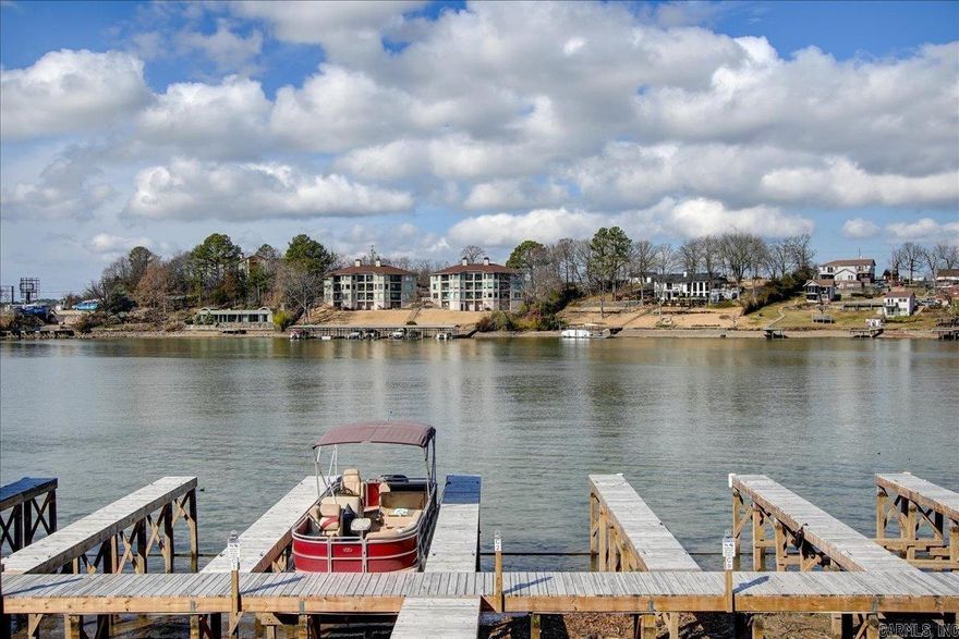 Walk-In Level condo on Lake Hamilton! "No stairs" entry and it comes with a boat slip! Come see this beautiful 2 bedroom, 2 bathroom condo on Lake Hamilton - currently being used as a short-term rental. Selling fully furnished and with a boat slip, this condo features tastefully decorated open living/dining/kitchen areas, granite countertops, stainless appliances, master bedroom with large walk-in closet & private ensuite bathroom. Second bedroom also has private hall bathroom. Assigned parking directly in front of the condo, and a great balcony for your morning coffee or evening "happy hour" - also a great spot to watch the beautiful sunsets and holiday fireworks over Lake Hamilton. Call today for your private showing!