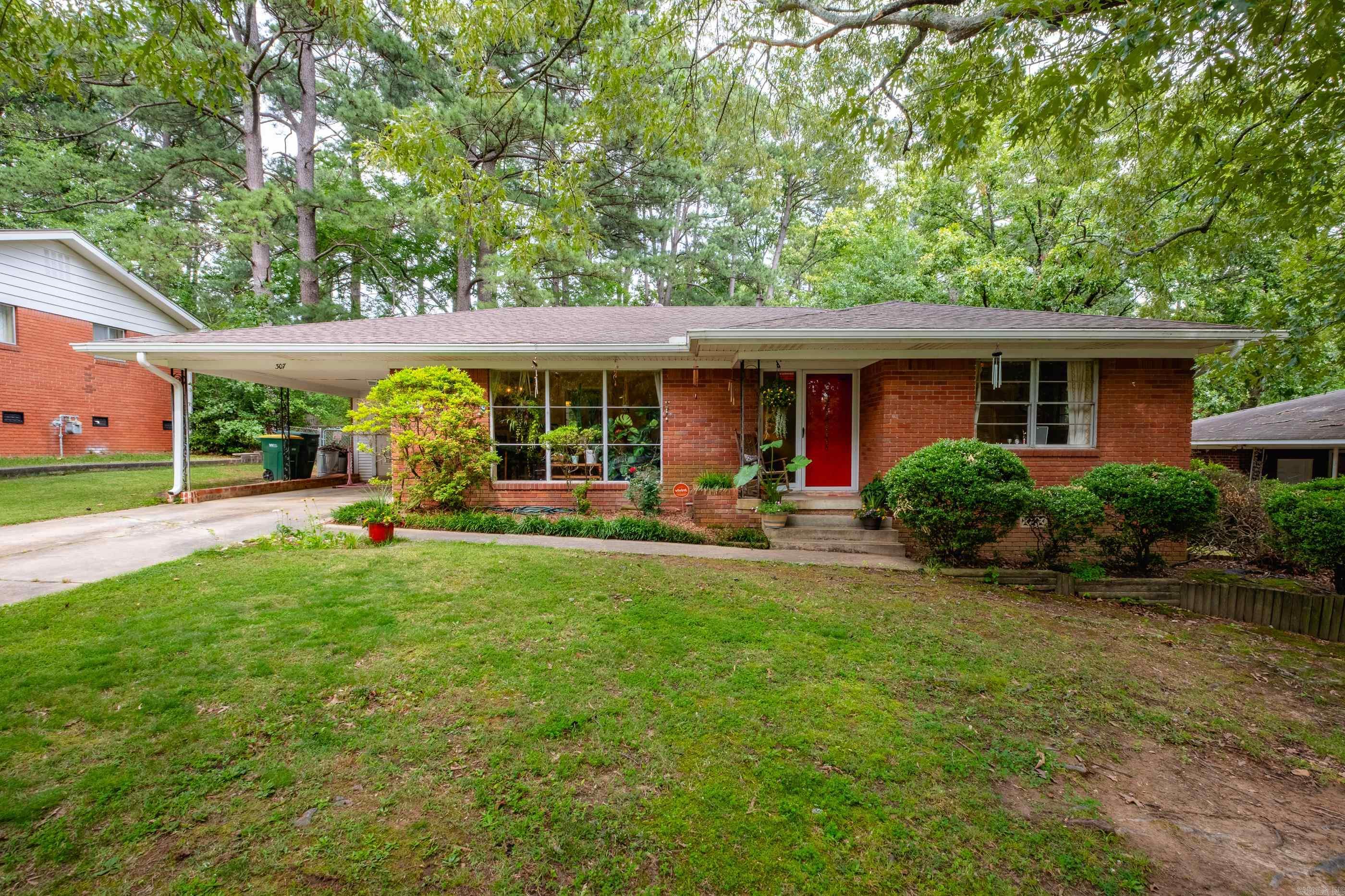 Open House, Sunday (6/22) from 2:00pm-4:00pm! This charming 3-bedroom, 1.5-bathroom, single-level home is nestled on a spacious, tree-shaded lot in an established midtown neighborhood. This residence features beautiful hardwood floors throughout an open living and dining area, highlighted by a stunning picture window that fills the space with natural light. The kitchen offers ample cabinetry and flows seamlessly to a separate laundry room. The three bedrooms are good sized and feature hardwood flooring as well. Step outside to a serene, fenced backyard oasis with lovely landscaping, a deck, and plenty of space for outdoor entertaining. Additional highlights include a newer roof (approx. 4 years), Hot Water Heater (2024), and a convenient central location. This well-maintained home blends classic charm with refined finish, making it move-in ready for its next owner!