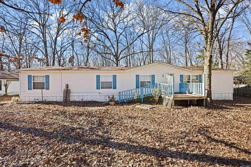 Spacious 3 bed, 2 bath home offering 1,960 sq ft on 3 level acres just outside city limits. Built in 1999, the private primary suite features his-and-her bathrooms with a jetted tub and walk-in shower. Enjoy a screened-in porch and fenced area perfect for goats or other animals. Property includes a huge detached garage/workshop, a detached barn with storage, and 3 unfinished tiny homes with water, septic, and some electric, ideal for Airbnb, guests, or a man cave/she-shed. Three concrete slabs already in place for additional tiny homes. Endless possibilities!