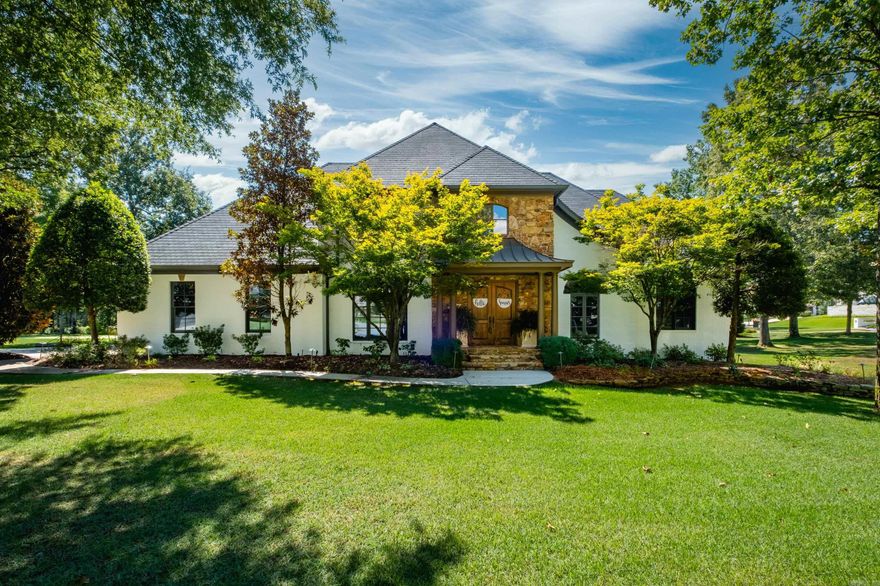 Stunning home with thoughtful updates and exceptional spaces for both everyday living and entertaining. A welcoming two story foyer opens to gorgeous, newly refinished hardwood floors throughout and fresh interior and exterior paint. The impressive great room features a striking rock fireplace and a wall of windows overlooking the covered porch and backyard. The fantastic kitchen offers new double ovens, abundant storage and counters. Formal and informal dining areas, as well as a cozy hearth room is perfect for gathering. The main level also includes a spacious primary suite with a spa bath featuring heated tile floors, Office/Study plus a guest bedroom suite with bath access from both the bedroom and hall, laundry and half bath. Upstairs are four large bedrooms, two connected by a shared bath and two positioned near a separate hall bath, along with a theater room featuring a separate snack and seating area and an additional space ideal for storage or a home gym. The backyard oasis is designed for year round enjoyment with a sparkling pool, relaxing hot tub, and covered outdoor living area. Additional features include a whole-house generator and a three-car garage. Come see!