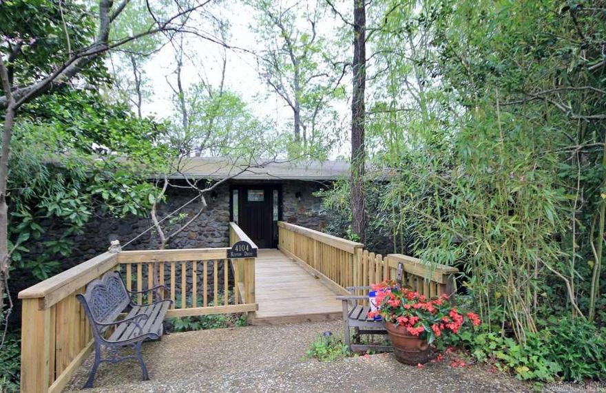 Native stone contemporary tucked away on lg. private lot w/waterfall, koi pond, screened-in upper porch & a lower porch w/hot tub. Interior crown jewel is the remodeled chef's kitchen & hearth room w/WBFP. Downstairs is a 3rd BR w/en suite bath, family room, lg. laundry rm. & access to 2-car carport currently enclosed as a workshop (could be re-converted). 9-yr old hybrid H/A, Marathon HWH, roof installed in 2005, lots of insulation. A well-maintained, wonderful property! 24-hr. notice preferred.