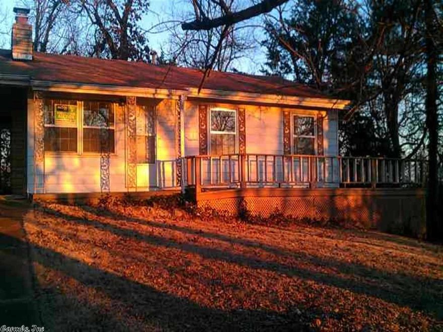 Cute home has wrap around deck, fireplace and eat-in kitchen.