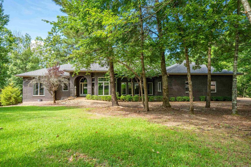 This stately home sits on 221' of Lake Estrella frontage at the end of a beautiful cul-de-sac. The expansive, single-level design offers a split floorplan, a well-appointed office (could be converted to a 4th bedroom if needed), a sizable kitchen + hearth room combination, and formal living and dining spaces. Premium finishes include mahogany flooring, wall-to-wall windows, exotic marble, high ceilings, and solid wood cabinetry and built-ins. Its brick exterior and 700' of Trex decking were designed to last. Not to be overlooked are the 3-car garage + separate 500 sqft garage for additional storage. Enjoy the beautiful views from both covered and open-air decks or the waterfront patio. This listing is truly special.