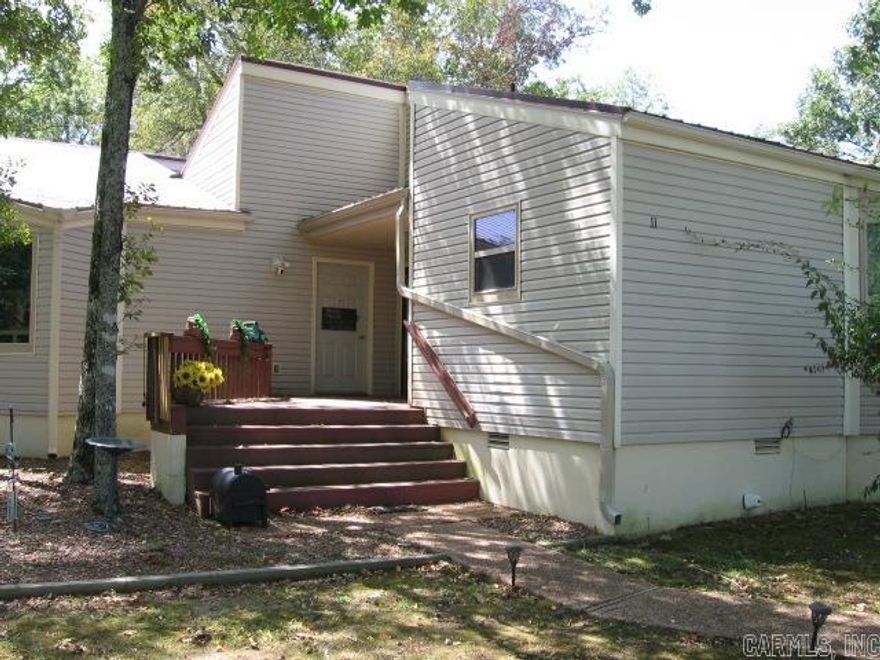 ONE-LEVEL CONDO WITH NUMEROUS UPDATES!!.  This 1 BR, 2 Ba unit is comfortable and cozy.  There is also a Murphy Bed in the living room for another sleeping space when you host guests! The kitchen has lots of room, and looks into the dining area.   UPDATES include LVP flooring, kitchen appliances, large sliding glass door in BR to deck, energy efficient windows, light/fan fixtures, stacked washer/dryer.  Flooring in kitchen & bathrooms is tile.  It's nestled in the complex and overlooks a green space area in the back.  Enjoy a quiet spot on the back deck to watch the birds.  Ownership allows you membership to all Resort amenities, such as pools, parks, golf, minigolf, marina rentals, etc.