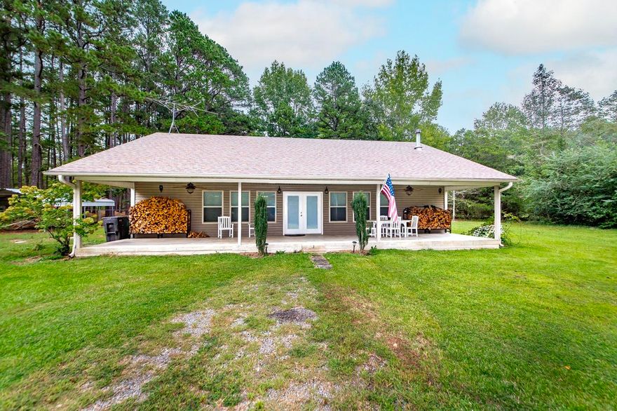 Embrace the ultimate lake lifestyle in this charming ranch home, perfectly situated just half a mile from the water's edge. This turn-key ready retreat offers 1,500 square feet of inviting living space, featuring two comfortable bedrooms and one-and-a-half baths. The bright and airy open-concept layout creates a seamless flow between the kitchen, dining, and living areas, establishing an ideal setting for both entertaining guests and quiet relaxation. Large windows bathe the interior in natural light, enhancing the sense of peace and connection to the outdoors. Its versatile appeal makes it a perfect weekend getaway, a serene full-time residence, or a lucrative short-term rental investment. One of the home's most captivating features is the full-length covered front porch, an idyllic spot for sipping morning coffee or unwinding in the evening after a day of adventure. Set on a generous 0.72-acre lot, the property provides ample outdoor space for gardening, recreation, or simply soaking in the peaceful, natural surroundings. With boating, fishing, and kayaking just moments away, this property is your gateway to endless lakeside fun. Priced to sell!