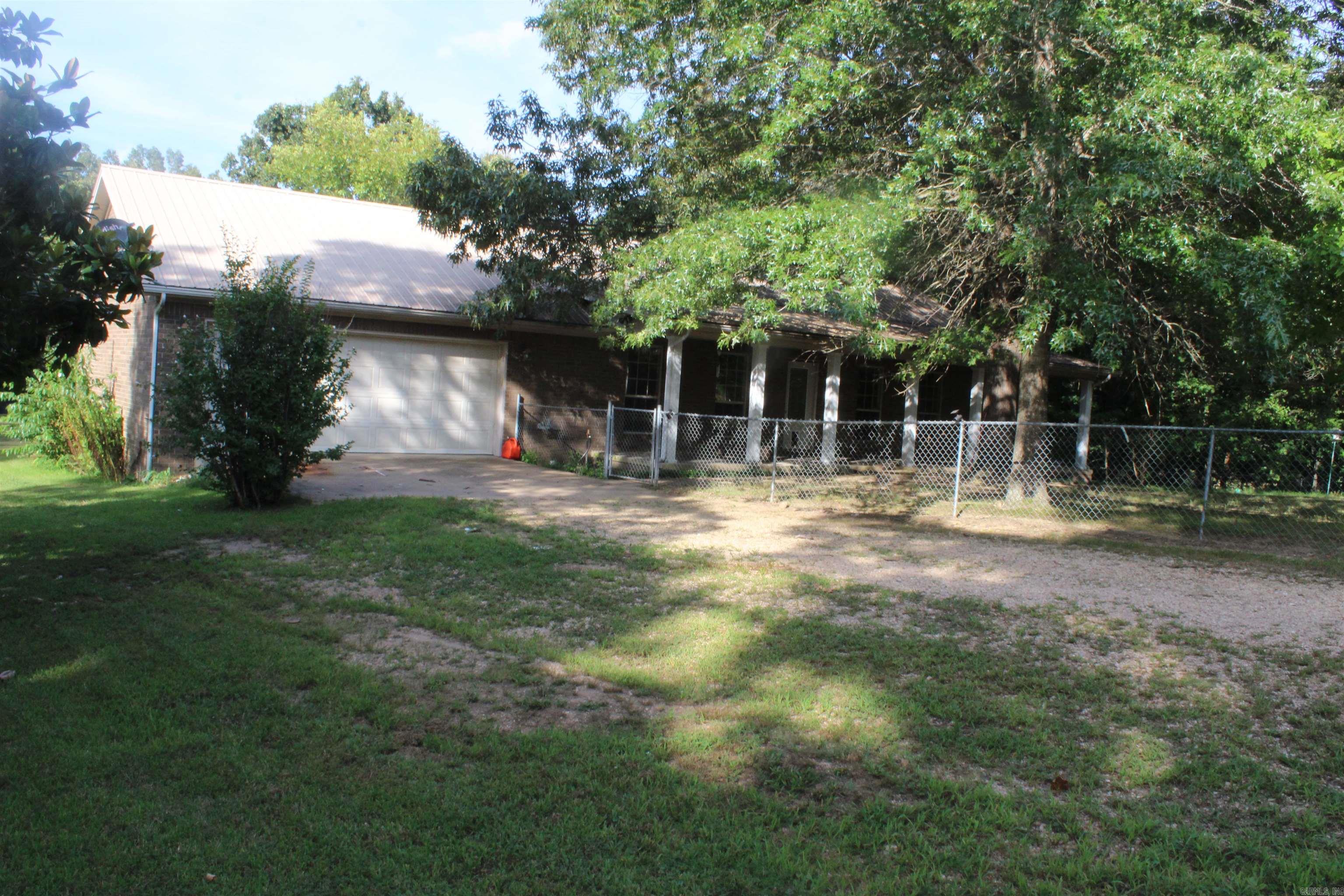 Peaceful country living on 5.40± acres just 10 minutes from Marshall for all your daily essentials! This 2-bed, 2-bath home offers 1,588 sq ft of cozy living space with hardwood and tile floors throughout. The primary suite includes a walk-in closet and private bath. A bit of TLC will bring out this home’s full charm. Enjoy the outdoors on the covered front porch, and the partially fenced yard is great for pets or kids, and take advantage of multiple outbuildings, storage sheds, and kennels—perfect for hobbies, pets, or potential income. An attached 2-car garage offers extra storage or workshop space. Fiber internet is available, making remote work or streaming a breeze. Just 20 minutes from the Buffalo National River for kayaking, hiking, and fishing, and close to the nostalgic Kenda Drive-Inn. Branson, MO is only 1.5 hours away for shopping and entertainment. A perfect weekend escape or forever home with room to grow!