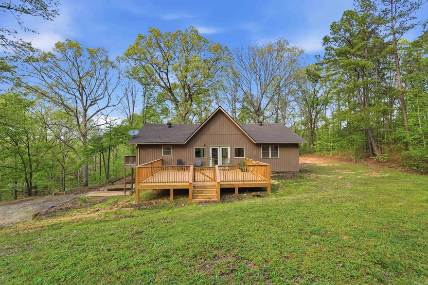 Welcome to your own private slice of Arkansas paradise! Nestled on 6 acres of beautiful, wooded land, this fully remodeled country home offers the perfect blend of comfort, style, & outdoor living. Featuring 6 spacious beds & 3 updated baths, there’s room for everyone. Step inside to a stunning living room w/ soaring vaulted ceilings, & a floor-to-ceiling stone fireplace that creates a warm, inviting centerpiece. The kitchen is a true showstopper with beautifully crafted countertops made from locally sourced wood, new appliances, & picturesque views of the surrounding trees. The primary suite offers a private retreat w/ its own dedicated laundry area, w/ an additional laundry space downstairs adds convenience for everyday living. Downstairs enjoy the 2nd fireplace, bonus space w/ 3 beds & 1 bath Extensive updates include new LVP flooring, roof, siding, windows, gutters, septic, plumbing/lighting fixtures, & a French drain.  The brand-new deck is the perfect spot to relax & take in the scenery. Outside, enjoy a 20x30 shop ideal for hobbies or workspace, plus plenty of room to explore or even deer hunt right in your own backyard. Also see MLS 26013127 home w/ 8 additional acres avail