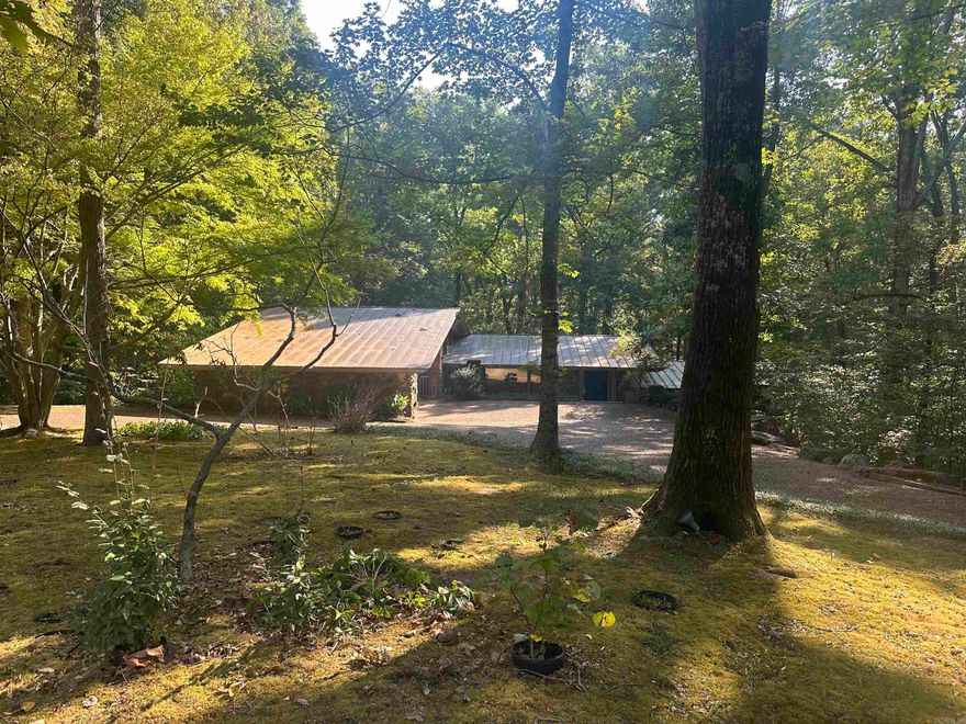 This stunning 3-bedroom, 2 full bath & 2 half bath residence (˜3,210 sq ft) sits on 2.2 acres and was crafted in 1967 by Memphis architect Buddy Hord. Inspired by the Red Apple Inn and built with hand-set stone from Cleburne County  near Heber, the home offers a formal dining room, living room, a mini bar in the large great room, beautiful sunroom, basement, deck overlooking the lake, fenced side yard, sealed slate flooring throughout, copper roofing, hot tub, circle drive, low maintenance yard, and a double carport — a perfect blend of architectural character and serene lakeside living. This home offers a very private setting and is a must see, offering so much character and personality!  Give us a call today   Connie Rice 870-270-1800 Chandle Rice 870-270-2201