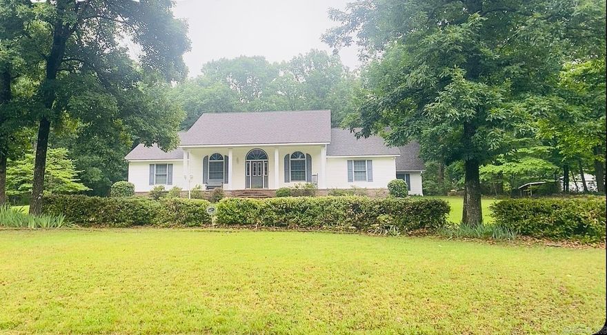 Set on 3 acres in the sought-after Mountain Aire community, this beautifully maintained 3,200 sq. ft. home blends Southern charm with thoughtful design. A circular drive, white columns, lush landscaping, and seasonal lake views create a warm welcome. Inside, 10-foot ceilings, new hardwood floors, and elegant archways lead to spacious living and dining areas. The kitchen features granite countertops, tile backsplash, island seating, abundant cabinetry, and a large walk-in pantry. A generous utility room includes built-ins for added convenience. The split floor plan offers spacious secondary bedrooms, while the private primary suite includes dual walk-in closets, double vanities, and ample storage. Upstairs, a large bonus room provides flexible space for recreation, work, or guests. Additional highlights include an oversized two-car garage with an underground storm shelter, partially fenced outdoor area, and a large shop with covered storage for boats, vehicles, or equipment. The property also features a fenced garden, fruit trees, blueberry bushes, and herb beds. Residents enjoy access to Mountain Aire’s lakes, fishing, trails, and kayaking! Truly, a piece of paradise!