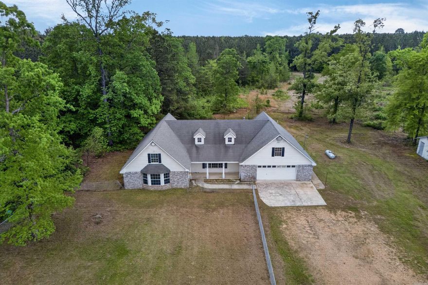 Welcome to 1480 Hwy 70 W in Dierks, Arkansas—offering space, comfort, and country living on 7 beautiful acres! This inviting home features a functional layout with plenty of room to spread out both inside and out.  Step inside to an open-concept kitchen and living area designed for everyday living and entertaining. The kitchen offers abundant cabinet space, warm wood finishes, and generous countertop areas, flowing seamlessly into the dining and living spaces. Large windows bring in natural light, creating a bright and welcoming atmosphere throughout.  The home also includes an upstairs den/bonus space, perfect for a second living area, game room, or home office. Bedrooms are well-sized, and the layout provides flexibility for a variety of needs.  Outside, enjoy the privacy and possibilities of your acreage, complete with a detached building that can be used as a shop, storage, or workspace. The land offers room for recreation, gardening, or simply enjoying the peaceful surroundings.  Conveniently located just a short drive from Lake Greeson, this property is perfect for those who love the outdoors while still wanting a comfortable place to call home.