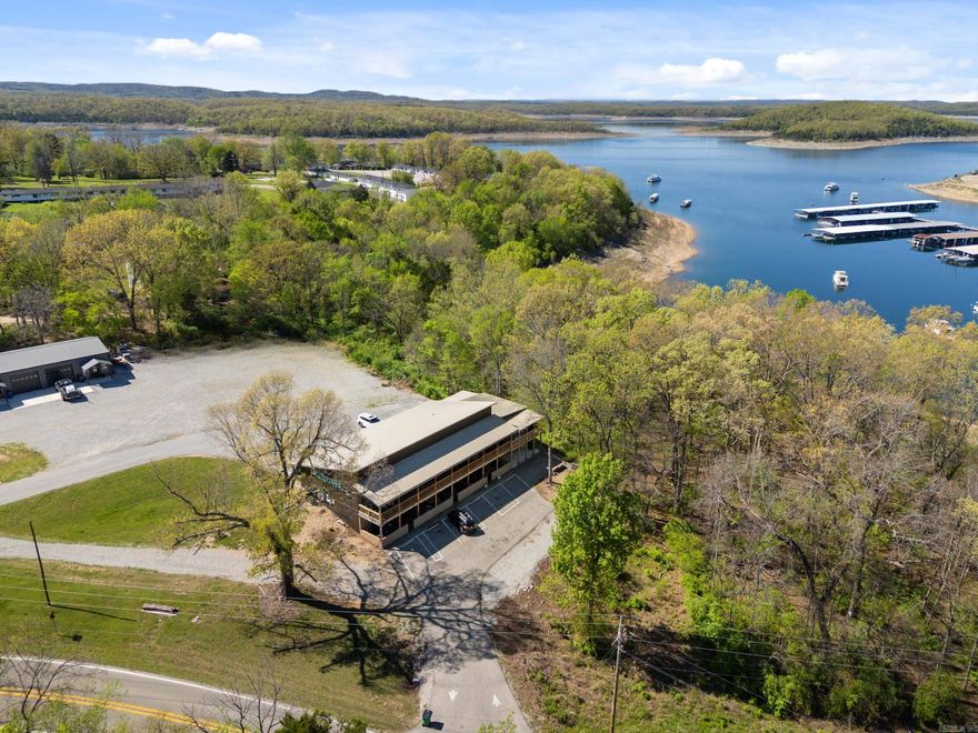 Welcome to your perfect lake getaway! This like-new 1 bedroom, 1 bath condo borders the  Government Strip, offering added privacy and a natural buffer , with a seasonal view of  beautiful Bull Shoals Lake and Bull Shoals Marina. Built just four years ago, this well  maintained condo features an open concept floor plan designed for easy living and  entertaining. The interior boasts durable acid stained floors, a convenient laundry room,  and a bright, inviting living space. The large primary bedroom features a walk-in closet. The  bathroom features a large vanity and tub/shower combo. Step outside and enjoy an  impressive 370 square feet of outdoor living, on your oversized porch or the large common  area, located on the side of the property for family gatherings and cookouts and complete  with bathrooms for your guests. Located just a few miles from the renowned White River,  famous for its world-class trout fishing, crystal-clear waters, and year-round outdoor  recreation, this property offers the best of both lake and river lifestyles. Currently used as a  short-term rental, this property comes fully furnished.