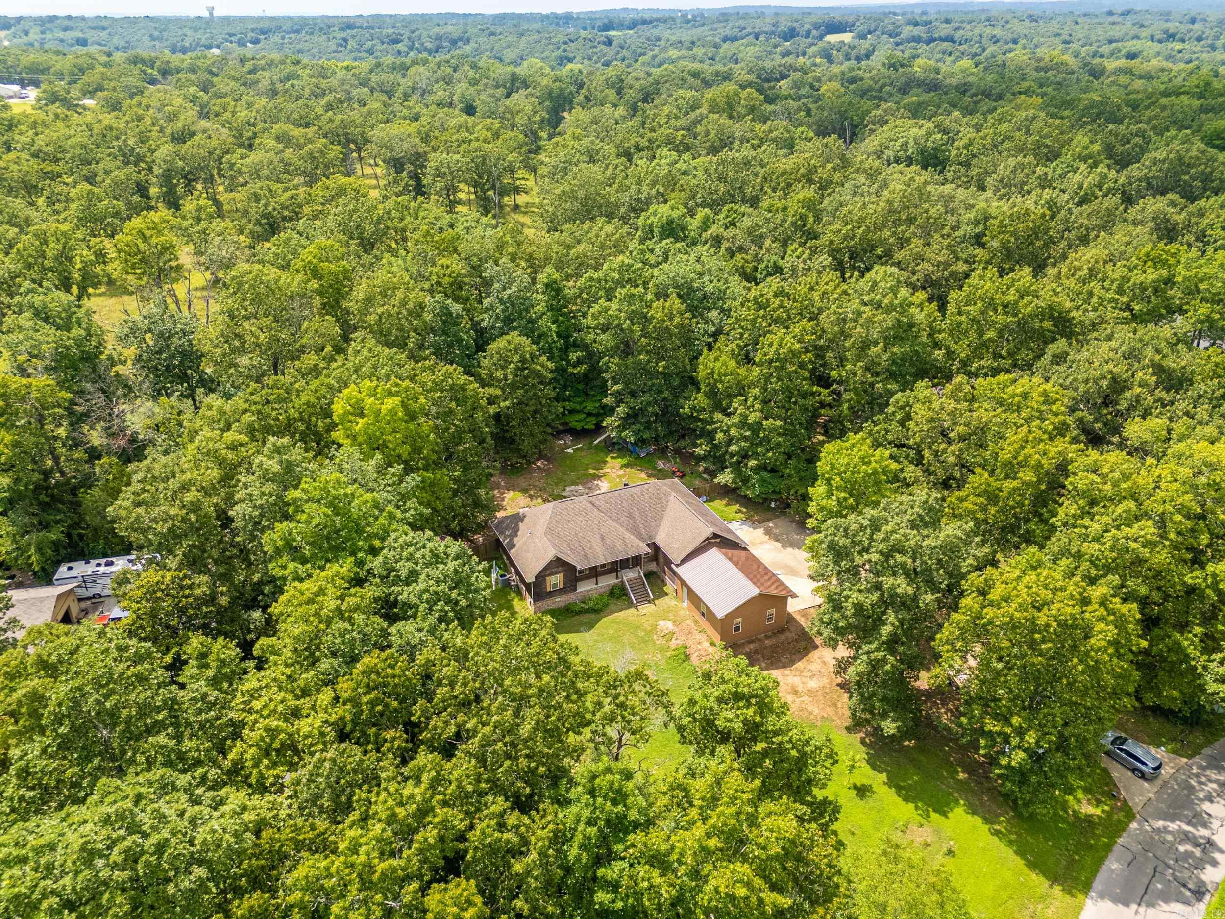 This stunning 4-bedroom, 2-bath cedar home offers space, style, and functionality all in one. With rich hickory floors and an open-concept living, kitchen, and dining area, it’s perfect for both entertaining and everyday living. The split-bedroom layout provides privacy, while the spacious primary suite features two walk-in closets and a luxurious step-in tile shower. There’s also a dedicated office space, a huge walk-in pantry, and an oversized laundry room for added convenience. The attached 4-car garage offers ample room for vehicles, hobbies, or storage. Outside, enjoy a large privacy-fenced backyard—ideal for gatherings, pets, or relaxing in peace. Located on a quiet street just minutes from town, this 1.5-story home combines thoughtful design with practical living. Don’t miss your chance to make it yours! Seller is offering a free 14 month home warranty through Home Warranty Inc. - Core Plan to buyer.