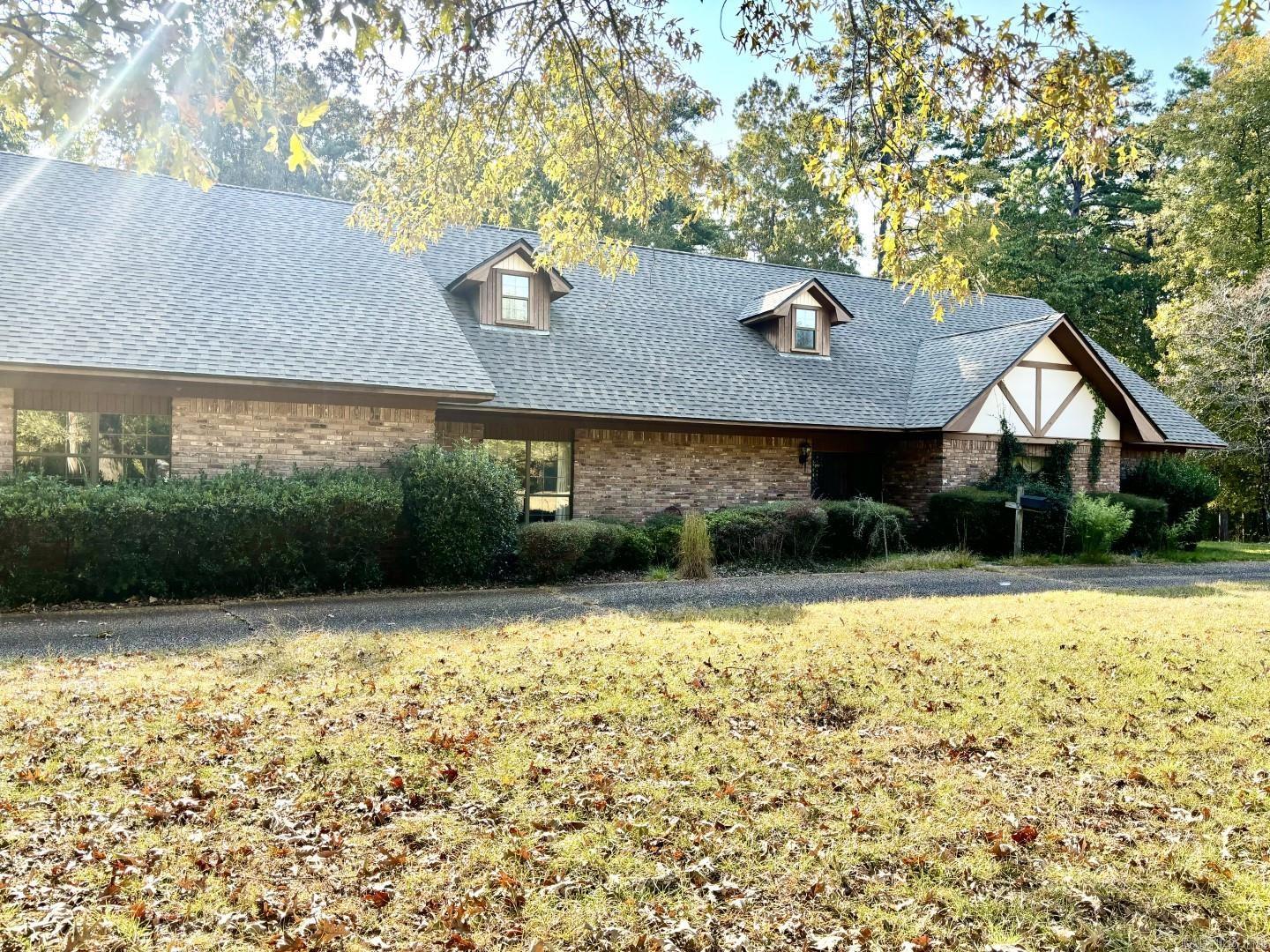 A stunning Tudor-style home sits on 4 acres of rolling terrain in a serene neighborhood. Spanning over 4200 square feet, it features 4 bedrooms and 3.5 bathrooms. The property boasts a spacious den, perfect for a family room or an additional large bedroom. The upper level includes a versatile bonus room.