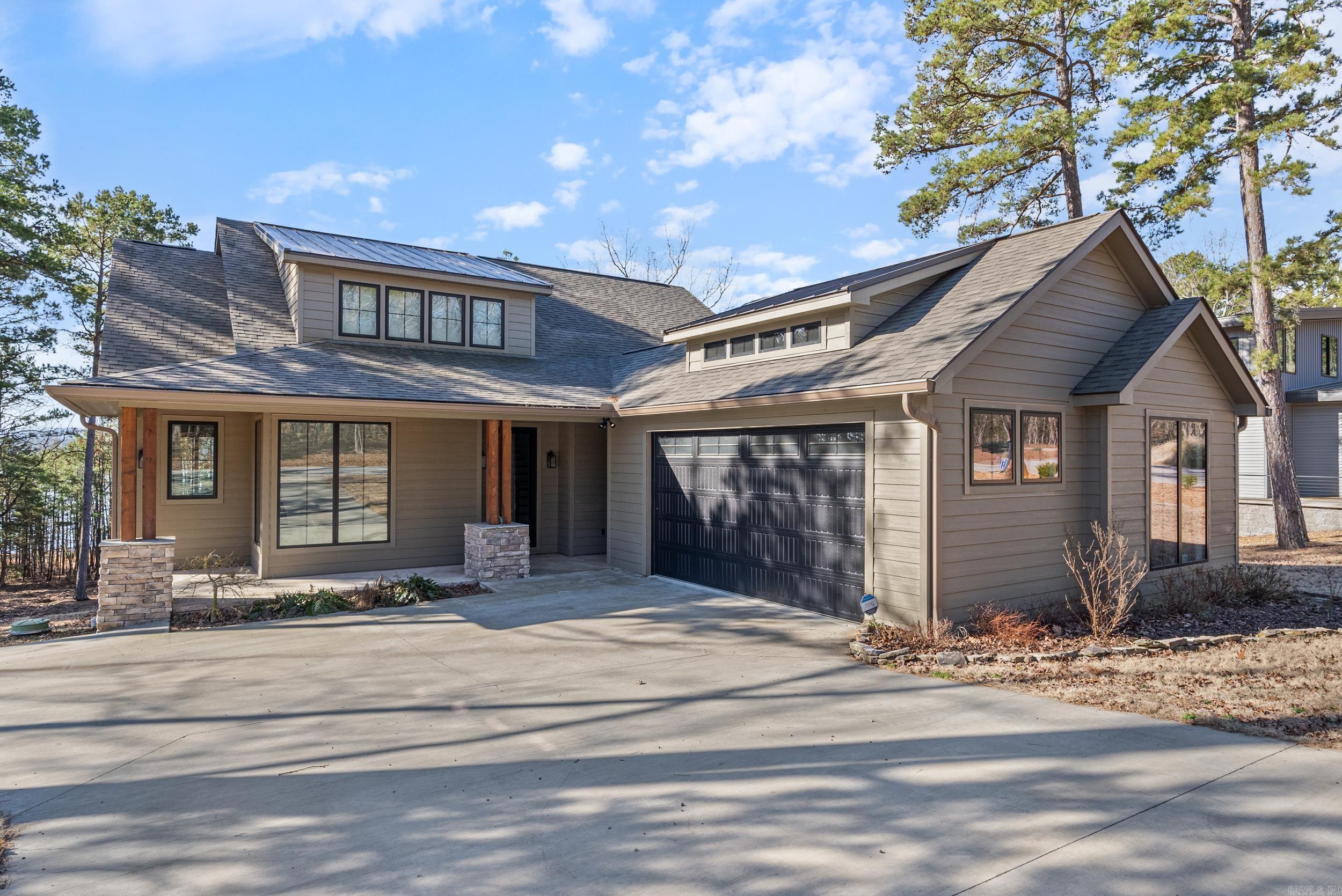 Welcome to your dream lakefront retreat nestled on the serene shores of Greers Ferry Lake. This custom-built home, completed in 2022, promises sophistication & comfort with stunning panoramic views that will take your breath away. Step inside to experience the beauty of upgraded wood floors & the comfort of energy-efficient spray foam insulation. Designed for durability & elegance, the home's exterior boasts LP SmartSide siding finished with factory-applied acrylic latex paint. Imagine yourself relaxing on the covered deck or the lower-level patio, both beautifully designed and wired for a hot tub, providing the ideal space for both entertainment & tranquility. The luxurious master bath offers a spa-like escape with its beautifully tiled shower & a soaking tub perfect for unwinding after a day of lake adventures. As you journey upstairs, you'll find two additional bedrooms, a bath, and a versatile loft area that can easily transform into a bunk room or an upstairs den, catering to your lifestyle needs. At the heart of this home is the open family/kitchen area, featuring a large island and an adjoining coffee bar/pantry area. Gentle walk to the water. Boat slip available $35,000