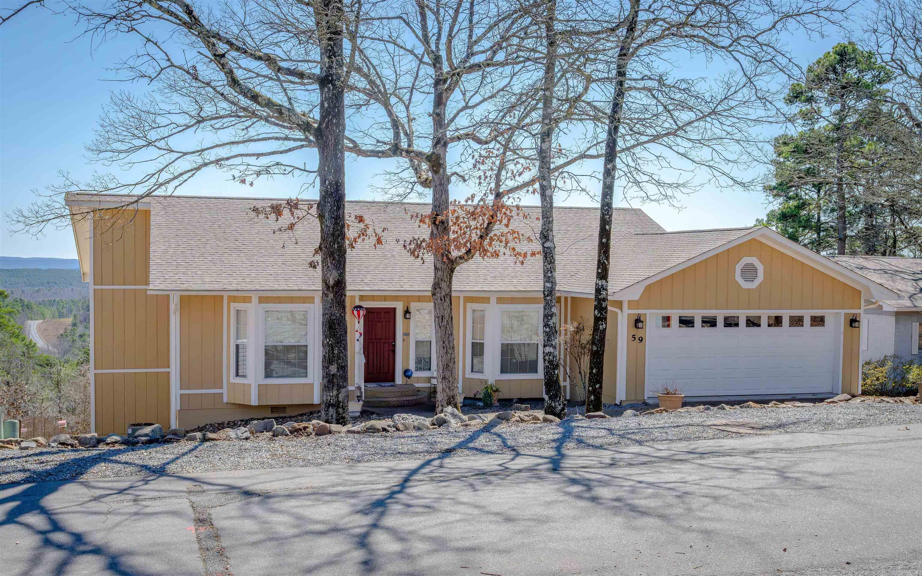 Discover breathtaking vista views and meticulously updated comfort in this exceptionally maintained home! Solar Panels provide average monthly electric bill of $15. Step inside to an inviting open floor plan on the main level, featuring a spacious living area seamlessly connected to the kitchen, dining room, and breakfast nook. The vaulted ceiling in the living room enhances the airy and bright atmosphere. Two bedrooms and two full bathrooms on this level provide convenient single-level living. The lower level offers a versatile family room, third bedroom, and third full bathroom, ideal for guests. A workshop space with exterior access provides ample room for hobbies or storage. Enjoy outdoor living on the full-size deck off the main level, perfect for entertaining or relaxing while taking in the expansive mountain views. The lower level also features a covered patio, extending your outdoor enjoyment. The fenced backyard features grass, a concrete walkway, and rock landscaping. Updates: 2024 roof & solar service; 2023 landscaping, fence, sprinklers; 2022 exterior paint, storage, solar, garage floor; 2021 interior paint, appliances, fixtures, LED lighting.