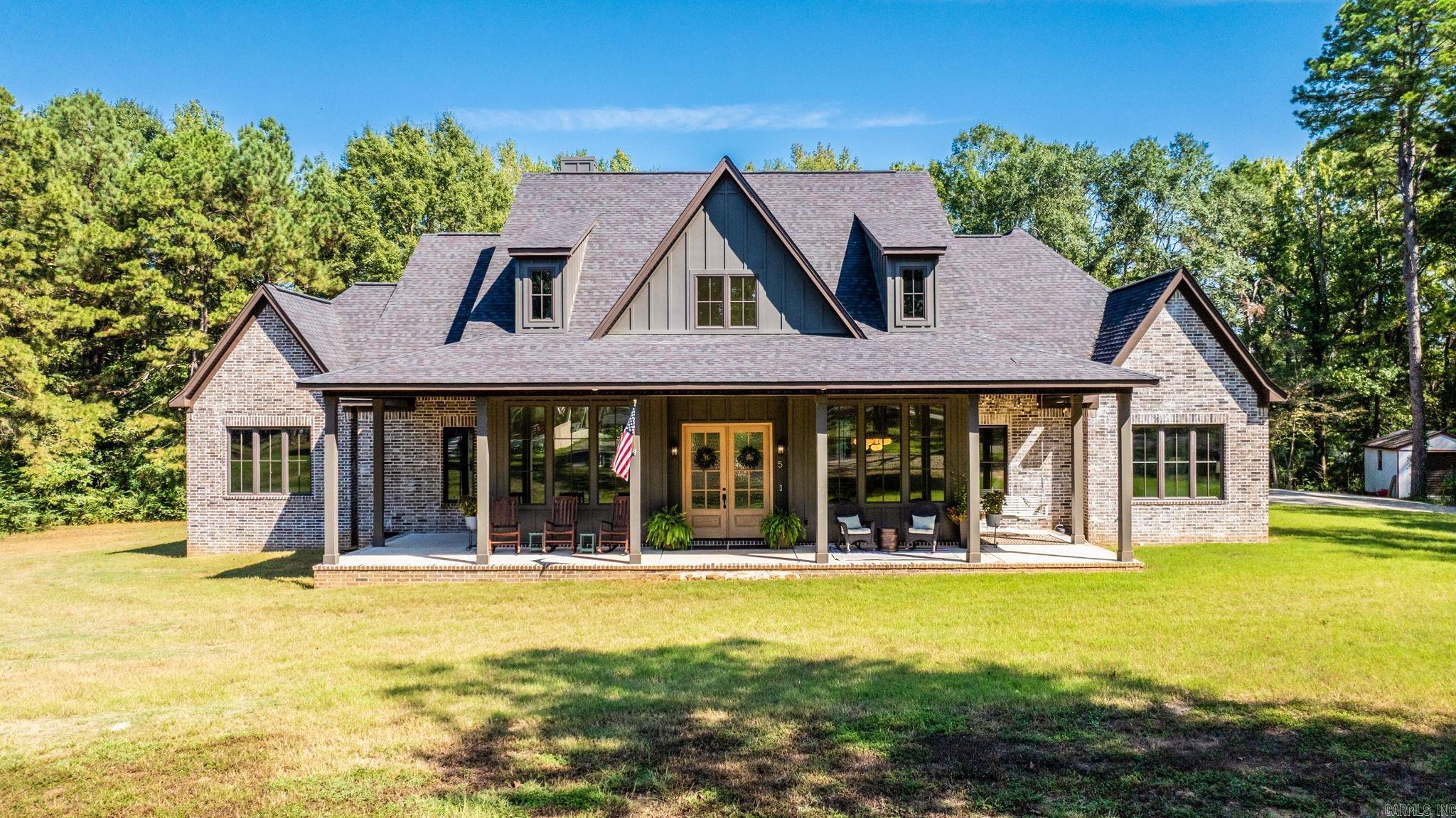Custom built home on 2.33 acres in Greenbrier. 4 beds, 4.5 baths, office, upstairs bonus room and outdoor oasis. Inside, find a spacious living area and open floor plan boasting vaulted ceilings, gas burning fireplace and office space. The living area flows into the kitchen and dining room, providing ample seating to host. The kitchen is complete with a double oven, warming drawer, gas cooktop, oversized island and butler’s pantry. The layout includes two guest bedrooms that share a Jack-and-Jill full bath, plus a private guest ensuite with its own full bath. The primary suite boats a spa-like bathroom with a soaking tub, custom walk-through shower and vast walk-in closet. Flowing into the laundry room, find abundant storage and a secure gun safe closet. Upstairs provides a large flex space that includes a full bath and convenient attic access. Step out back to your private outdoor oasis, complete with a wood-burning stove, expansive seating area and a full outdoor kitchen with bar seating, refrigerator, ice maker, dishwasher, sink & disposal and gas hookup for cooking appliances. Additional amenities include an in-ground storm shelter, rocked fire pit and a 10x12 utility building.