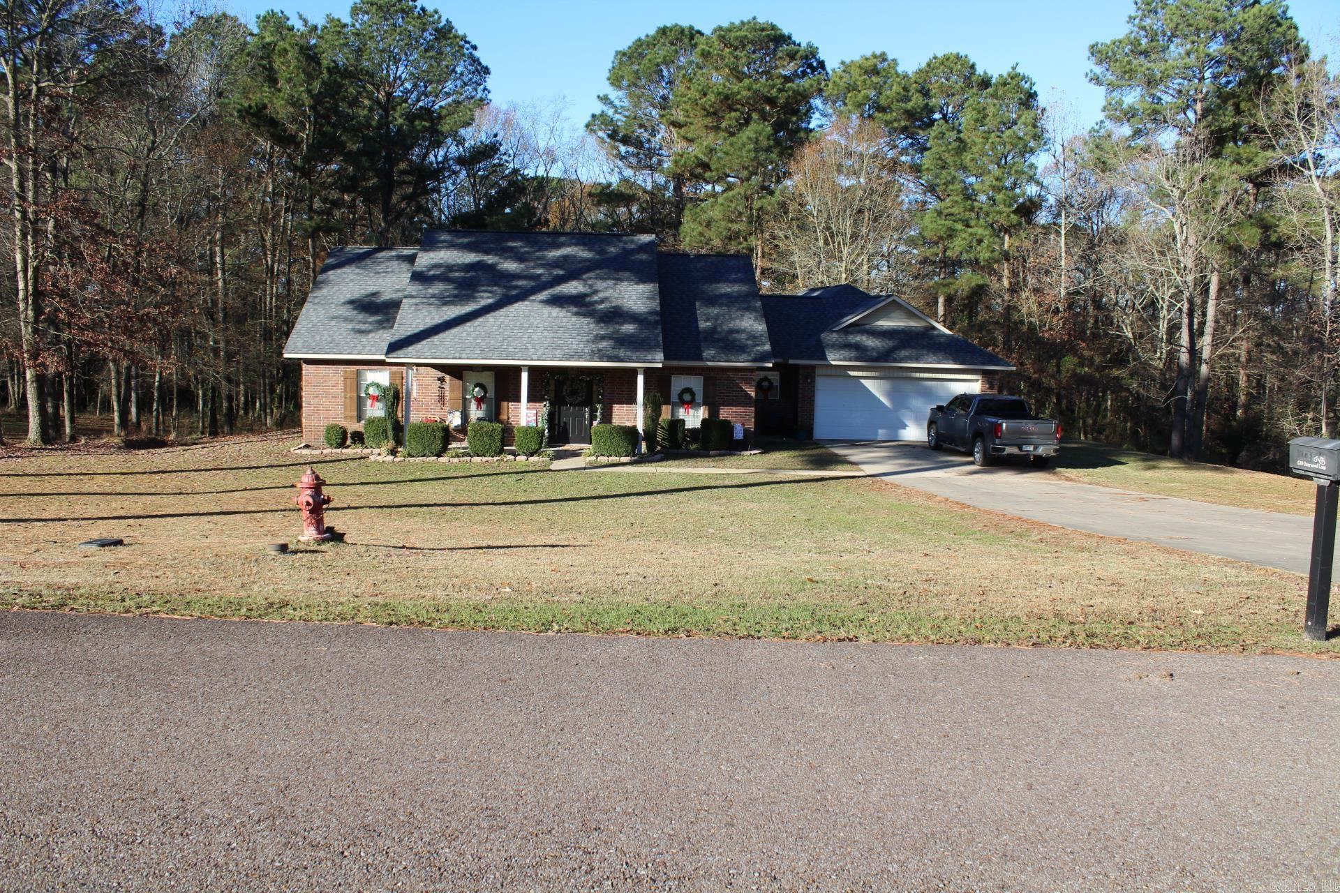 Brick home located in Deerwood Estates features approx. 2218 Sq. Ft. of living space situated on a approx. 1.5 acre wooded lot.  3 Bedroom, 2 full baths.  Home has formal dining area, spacious kitchen and a large living area that features a gas fireplace.  Crown molding throughout.  Large covered patio, wood privacy fence.  New Central AC & Heat.  Roof only 1 year old.