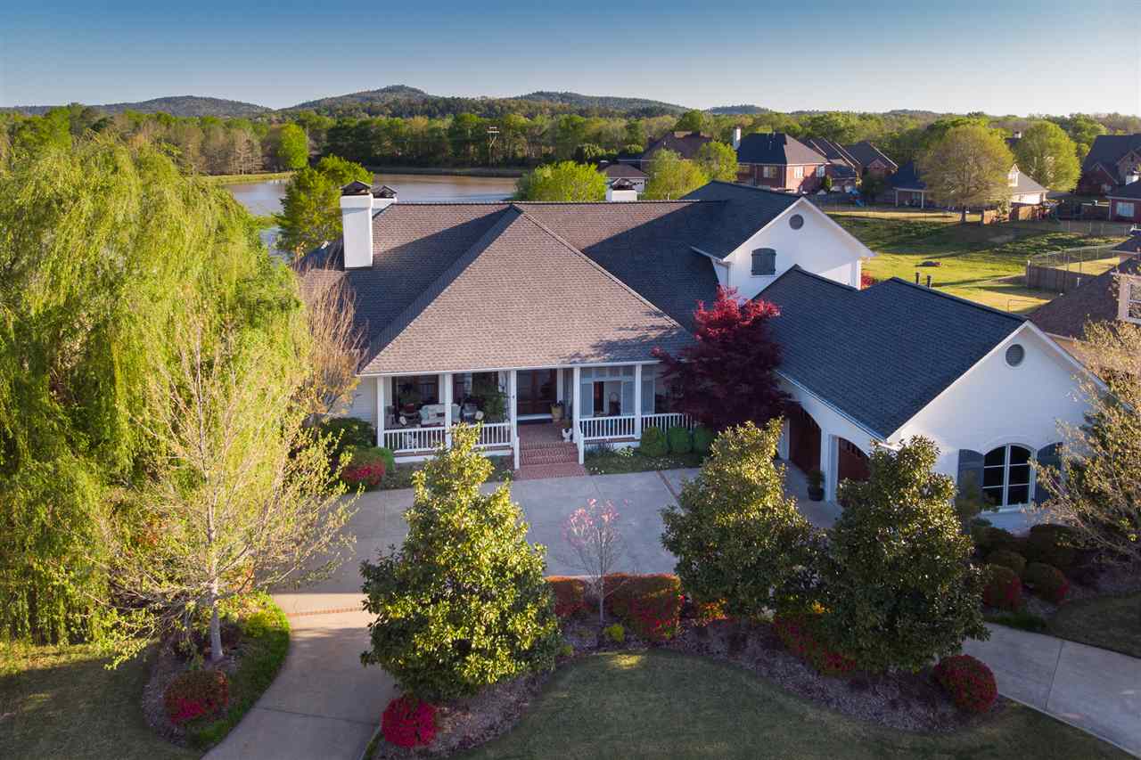 THE VIEW IS AMAZING!!!! This beautiful home is situated overlooking water fully equipped with an inground pool and so many extras! The master bedroom has a huge bathroom w/heated floors! The guest suite on the main level has a sink,mini fridge, and a view! There are 2 office spaces, craft room, keeping room, laundry, stairs to attic storage,central vacuum, ice maker, and 2 beds/ 1 bath/ bonus space upstairs. The front yard has a shutter porch, circle drive, and amazing landscaping! Agents see exclusions!