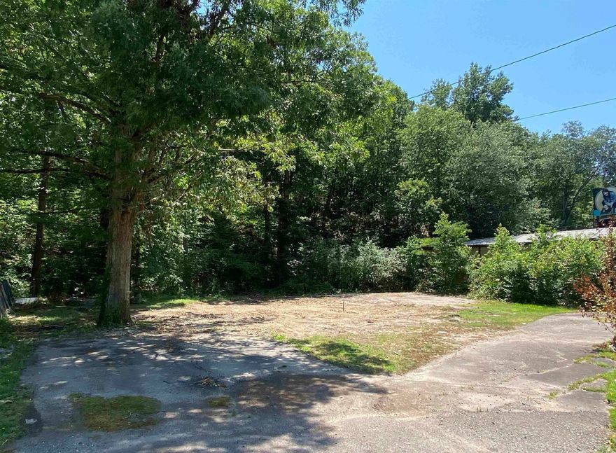 Vacant lot with utilities. City water, septic and electric available. Prior structure was raised. Remaining is a tranquil lot with stone surround fire pit, creek & storm cellar. Mobile Home allowed.