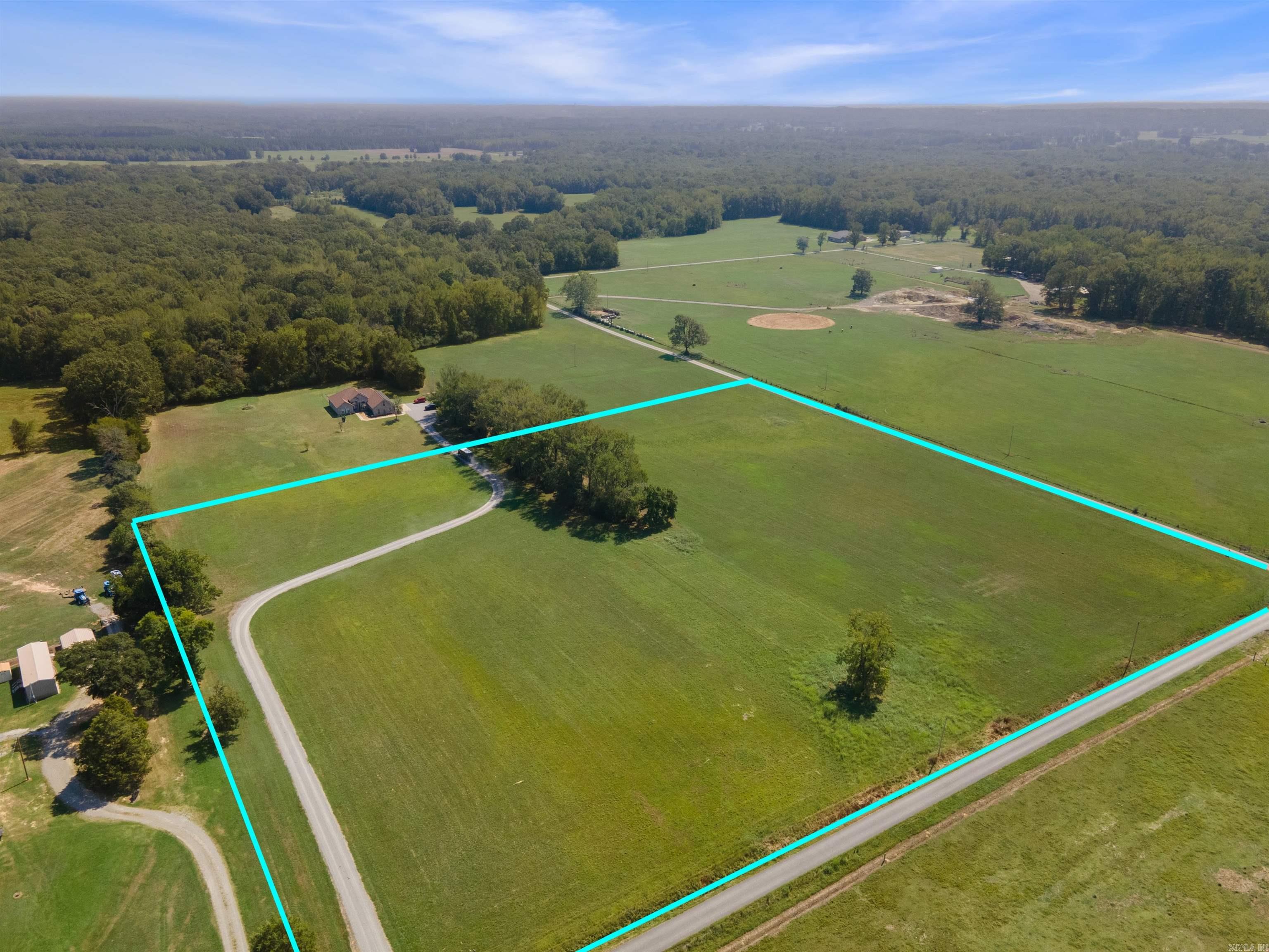 Here is your chance at over 12 acres on a corner lot. There is a drive way that cuts through the property but there are plenty of home sites to choose from! Currently the land is used for "growin', cutting' and bailin'". There is water and electric at the road for utilities. Come see if this property ise a good fit for you and your future dream home!
