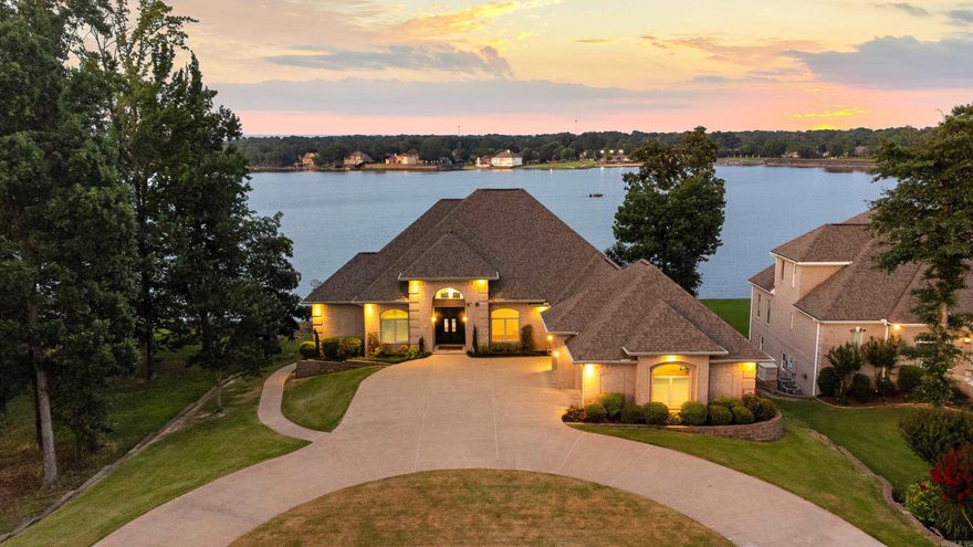 Experience refined lakefront living in this beautifully updated Hurricane Lake Estates home, stunning views from nearly every room. From the foyer, enter the formal living room with Brazilian teak hardwoods, expansive windows opening to covered outdoor balcony views—wired for surround sound, ideal for outdoor entertaining (see digital staging photos). The chef’s kitchen features double ovens, warming drawer, convection microwave, gas range, walk-in pantry, flowing into a cozy hearth room and elegant dining area. The luxurious primary suite boasts a double tray ceiling, fireplace, sitting area, spa-like bath with walk-in/roll-in shower, dual vanities, and a custom closet with pull-down rods. Designed for privacy and flexibility, the layout suits multigenerational living or guests, balancing comfort, independence, and connection. Built with energy-efficient ICF construction, the home delivers notably low utility costs. Premium features include a private elevator, whole-home generator, EZ floating dock, water filtration system, safe room, irrigation, and generous storage. The level, landscaped backyard leads to a private dock and retaining wall. Lakefront luxury living, Must See!