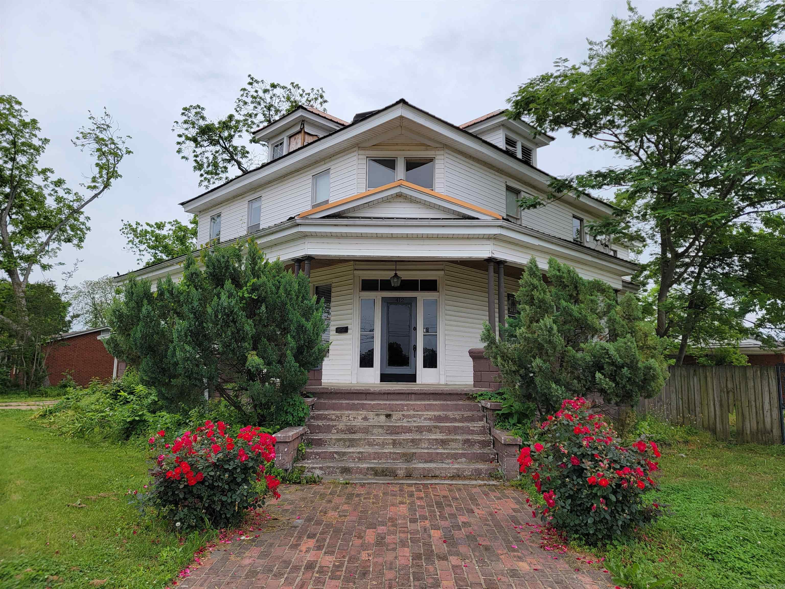 Envision this gal restored to all her former glory! There are SO many things to love here. Starting with the beautiful brick walk-way to the front porch, then inside a parlor with pocket doors, stunning stairway spindles, original fireplace tile. This beauty was built in 1926. Also available for your review is a Structural Soundness Report from a Licensed Structural Engineer done May 1, 2023. There are 3502 +/- sq ft with 5 large bedrooms, 2 1/2 baths, an upstairs kitchenette, a parlor, a living area and 2 staircases. If you have the vision, desire and ability to give this place some love...she can be GRAND!