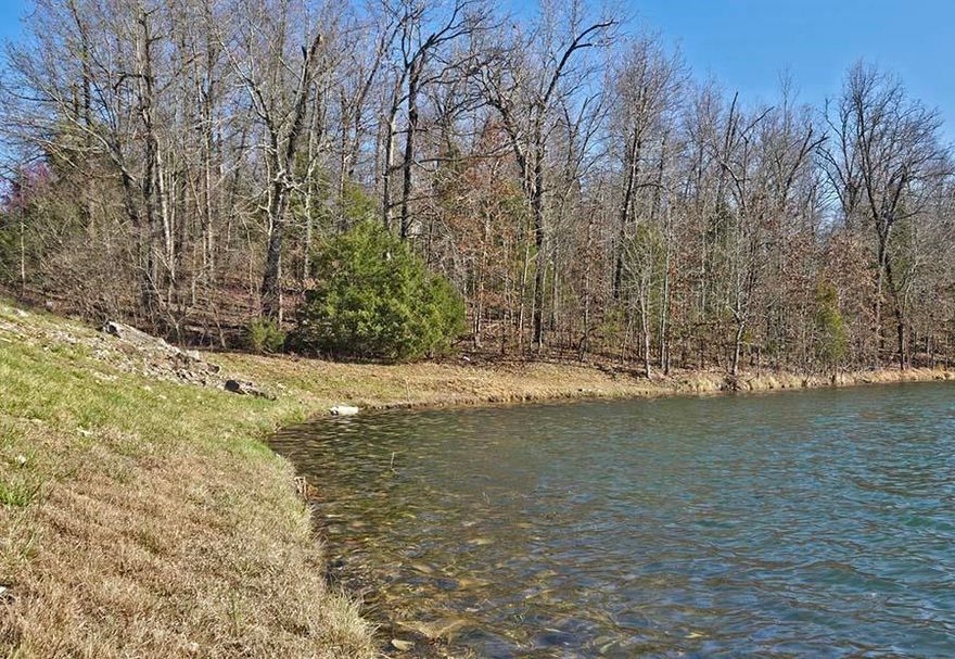 1.5 M/L WOODED ACRES ON LAKE AZTEC, 195 feet of lake frontage with the potential for a beautiful view from the lakeside windows and deck and lots of room for your private boat and swimming dock.  Fishing is great in this lake, known for crappy and bass... catch'em today, cook'em tonight!  What a life you could have here!  And very close to the South Golf Course, as well.  NOTE:  The legal description stated in a 1990's deed of this tract indicated 1.65 acres M/L, changed to 1.50 acres M/L in on-line advertising until a new survey could be obtained.  The current survey now available in our office shows the property to be 1.28 acres M/L, a tract on Aztec Lake located between Lot 1, Block 1 Togwatee Addition and a part of the Cherokee Road (Hwy 175) right of way and Hualapi Drive to the lake frontage , excepting that maintenance access near the dam retained by the Lake Aztec Dam legal description.  Boundary markers are now in place for clarification.