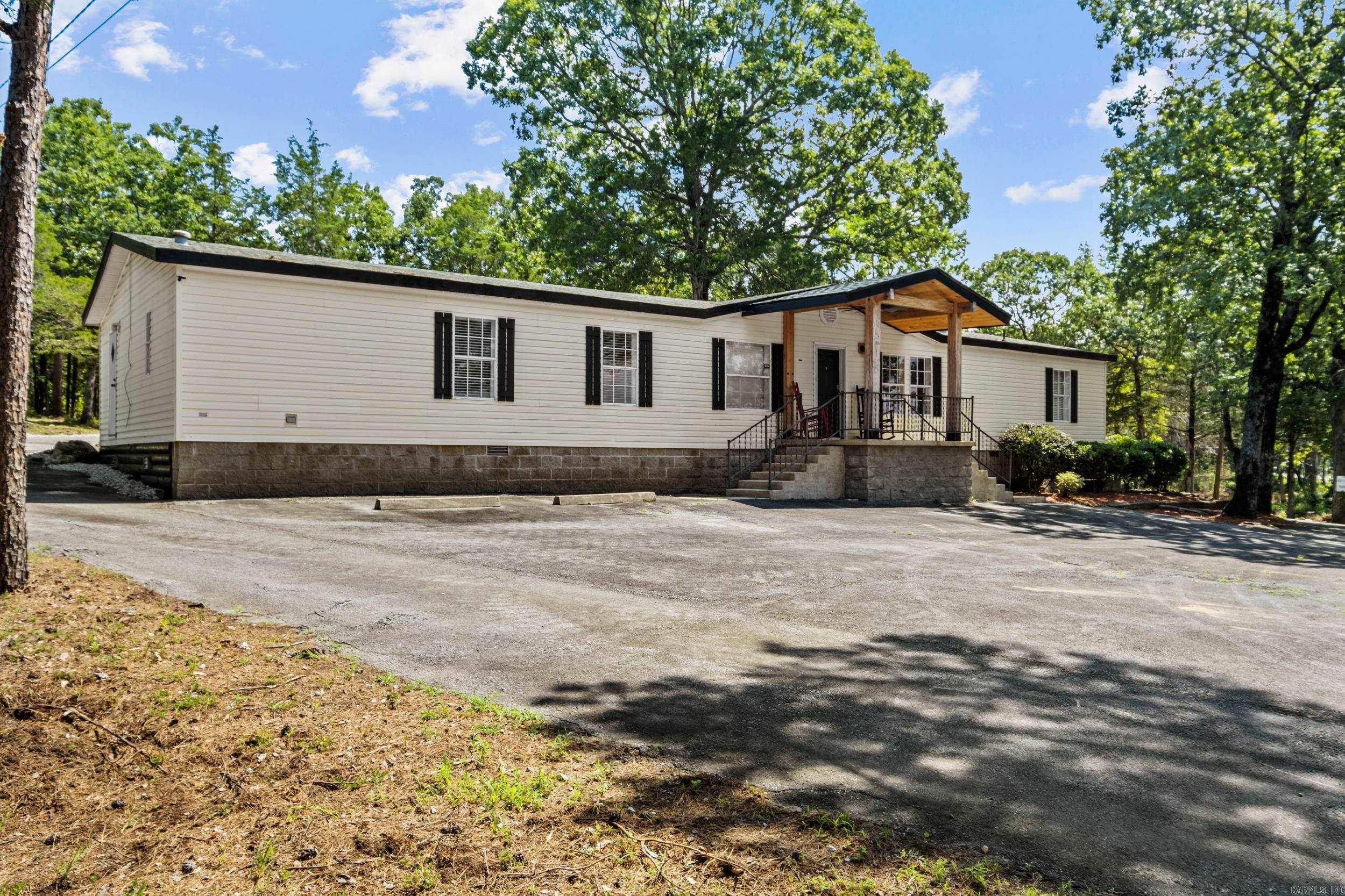 This beautifully updated 3-bedroom, 2-bath mobile home sits on a permanent foundation and offers approx. 1,950 sq ft of comfortable living space on a generous 1.75-acre lot. Recently refreshed with new flooring, paint, countertops, and more, this home is move-in ready with modern touches throughout. Enjoy plenty of parking space and a flexible layout that makes this property perfect as a primary residence, rental investment, or even a commercial opportunity. Located at the high-visibility corner of Wilburn Road and AR Highway 210, the location offers fantastic exposure for a business or unbeatable convenience for homeowners. Take in the stunning view of Sugarloaf Mountain from the front porch, and enjoy quick access to Greers Ferry Lake, the Little Red River, ASU Heber Springs, local hospitals, shopping, and more. Whether you're looking for a peaceful home base or a site for your next venture, this property has the location and versatility to fit your needs. The possibilities are truly endless!