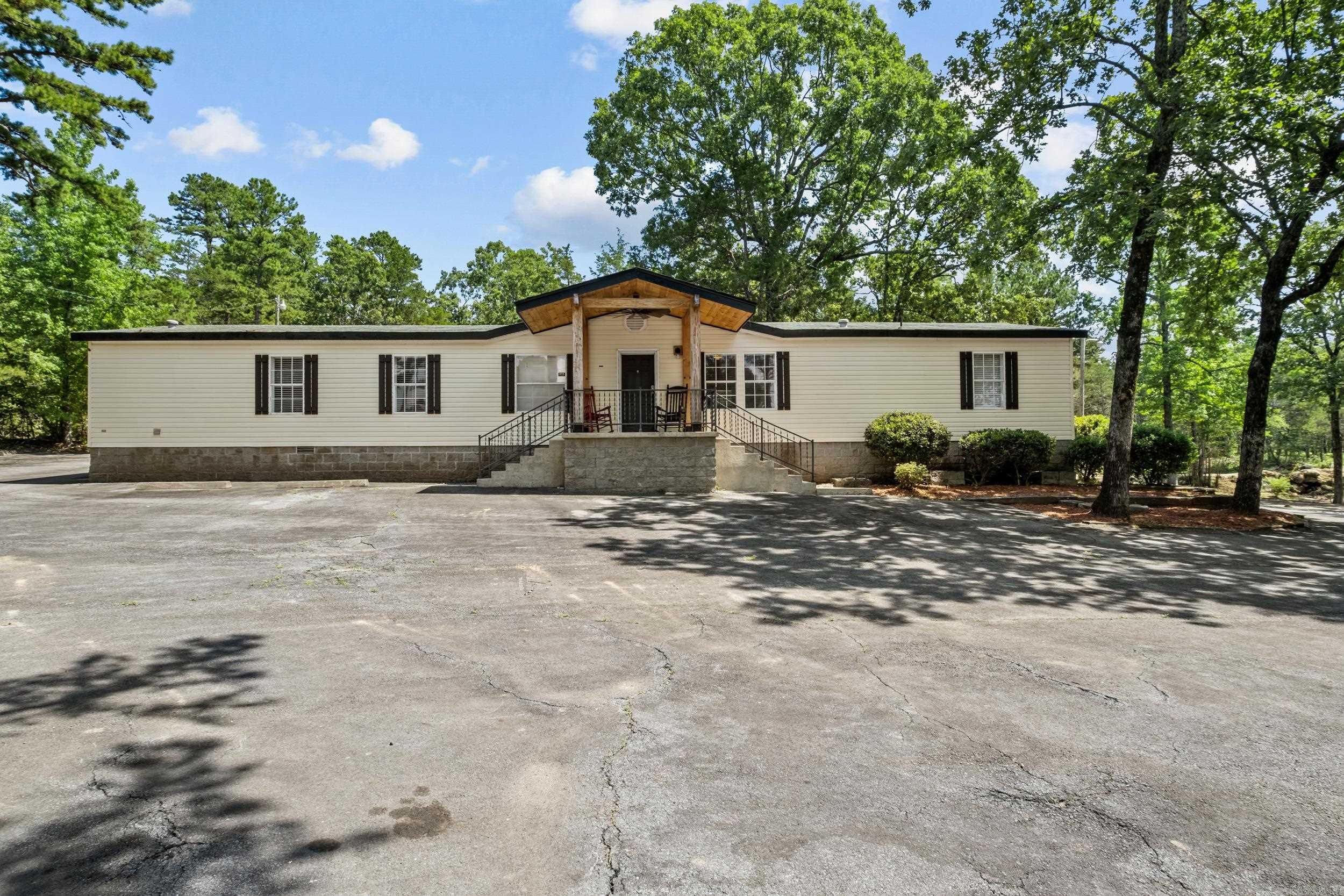 This beautifully updated 3-bedroom, 2-bath mobile home sits on a permanent foundation and offers approx. 1,950 sq ft of comfortable living space on a generous 1.75-acre lot. Recently refreshed with new flooring, paint, countertops, and more, this home is move-in ready with modern touches throughout. Enjoy plenty of parking space and a flexible layout that makes this property perfect as a primary residence, rental investment, or even a commercial opportunity. Located at the high-visibility corner of Wilburn Road and AR Highway 210, the location offers fantastic exposure for a business or unbeatable convenience for homeowners. Take in the stunning view of Sugarloaf Mountain from the front porch, and enjoy quick access to Greers Ferry Lake, the Little Red River, ASU Heber Springs, local hospitals, shopping, and more. Whether you're looking for a peaceful home base or a site for your next venture, this property has the location and versatility to fit your needs. The possibilities are truly endless!