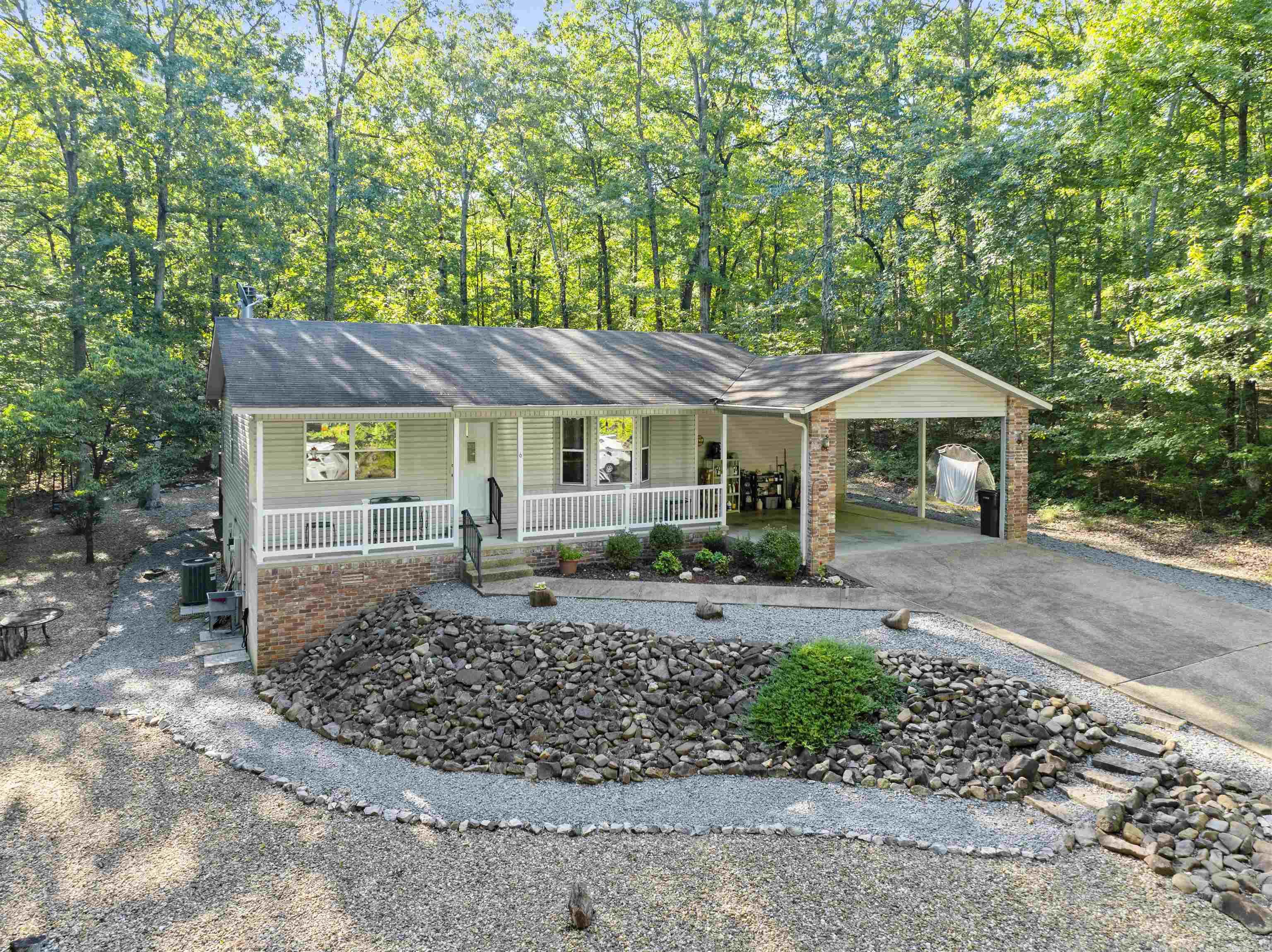 Privacy abounds in this cute and well kept home on a quiet cul de sac! Plenty of room in the back yard to keep a garden or put in a fence for your pets. This home features 3 beds, 2 baths, living room with a vaulted ceiling, deck for enjoying the back yard, and a lower level workshop/storage room. Sit on the front porch or back deck to enjoy the weather! The carport could be converted to a garage if desired and adjacent lots could potentially be purchased. Adjoining streets are great for walking or biking and this property is centrally located in the village. Come see all that Hot Springs Village has to offer! New Member Buy-in Fee due at closing.