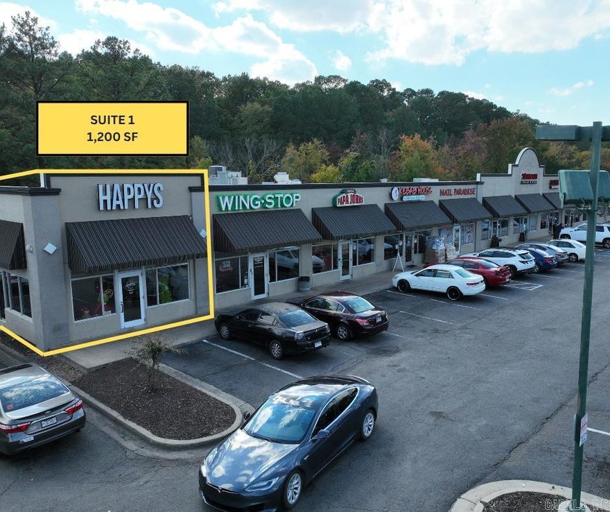 1,200 SF end-cap suite featuring an open floor plan with a built-in counter/bar area, private office, and restroom. Convenient side entry for customers or staff. Ideal for retail, service, or office use. Modified gross lease—tenant responsible for utilities and CAM.  1,200 SF end-cap suite Open floor plan with counter/bar area Private office and restroom Convenient side entry for customers or staff Excellent visibility near the Big Rock Interchange Easy access to I-430 and I-630 Ideal for retail, service, or office use Modified gross lease (tenant pays utilities and CAM)