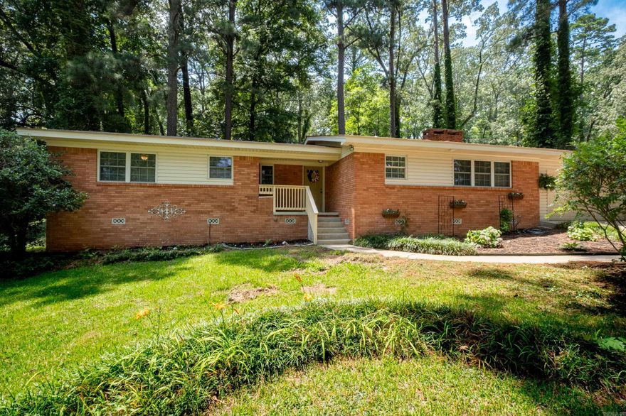 Nestled on a half acre lot in Beautiful Lake Subdivision is this wonderful brick, one level home.  Enjoy lake and dock access to the tranquil Lake Pauline.  Custom kitchen cabinets, granite countertops, stainless steel appliances updated in 2015.  The floor plan is a split bedroom plan and the primary suite is a peaceful retreat with a spacious bedroom and large walk in closet.  Original site built hardwoods in the living room lead to the deck with a large, fully fenced and private backyard.  This home is surrounded by natural beauty but close to the city.  New roof, carpet, garage door motor, door springs and rollers in 2024.  Come see this amazing home!