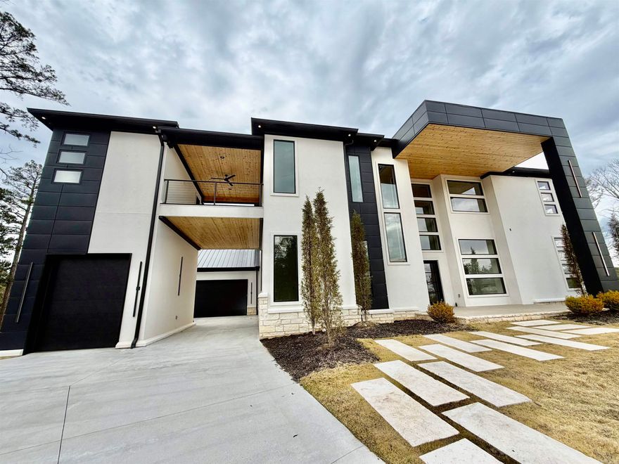 Stunning modern luxury at 84 Orle in highly desirable West Little Rock. This exceptional residence showcases dramatic floor-to-ceiling windows, soaring ceilings, and an open-concept layout filled with natural light. Refined finishes include luxury designer lighting, exotic stone accents, a handcrafted chandelier, and distinctive flooring throughout.   Built for entertaining, the home features dual kitchens and pantries, sleek appliances, high-end finishes, and a striking waterfall island. Enjoy premium lifestyle amenities including a private fitness room with wet bar, custom theater, and expansive balconies offering serene views. Complete with multi-car garages, elegant courtyard entry, and bespoke details at every turn, this is a rare opportunity in one of Little Rock’s most sought-after areas.