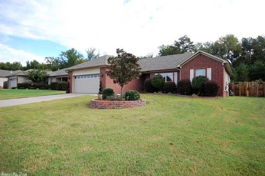 Don't miss this one! This darling home is like NEW.  Interior features 4 bedroom, 2 bath split bedroom floor plan. Living room has fireplace and beautiful hardwoods. New wooden floors through out the house.  Master bedroom is large with large master bath featuring separated double sinks, jetted tub, shower and walk-in closet.  Amazing back yard features oversized tiled patio with custom built pergola, stucco wood burning fireplace, detached storage building and backs up to tree line for privacy.