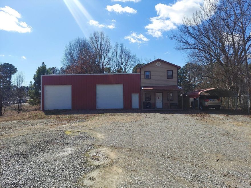 Two story building used as an auto sales lot. The upstairs has been plumbed for bathroom and shower and is insulated. Building has metal roof and two 11ft doors. Natural gas on the property and located on City Sewer.