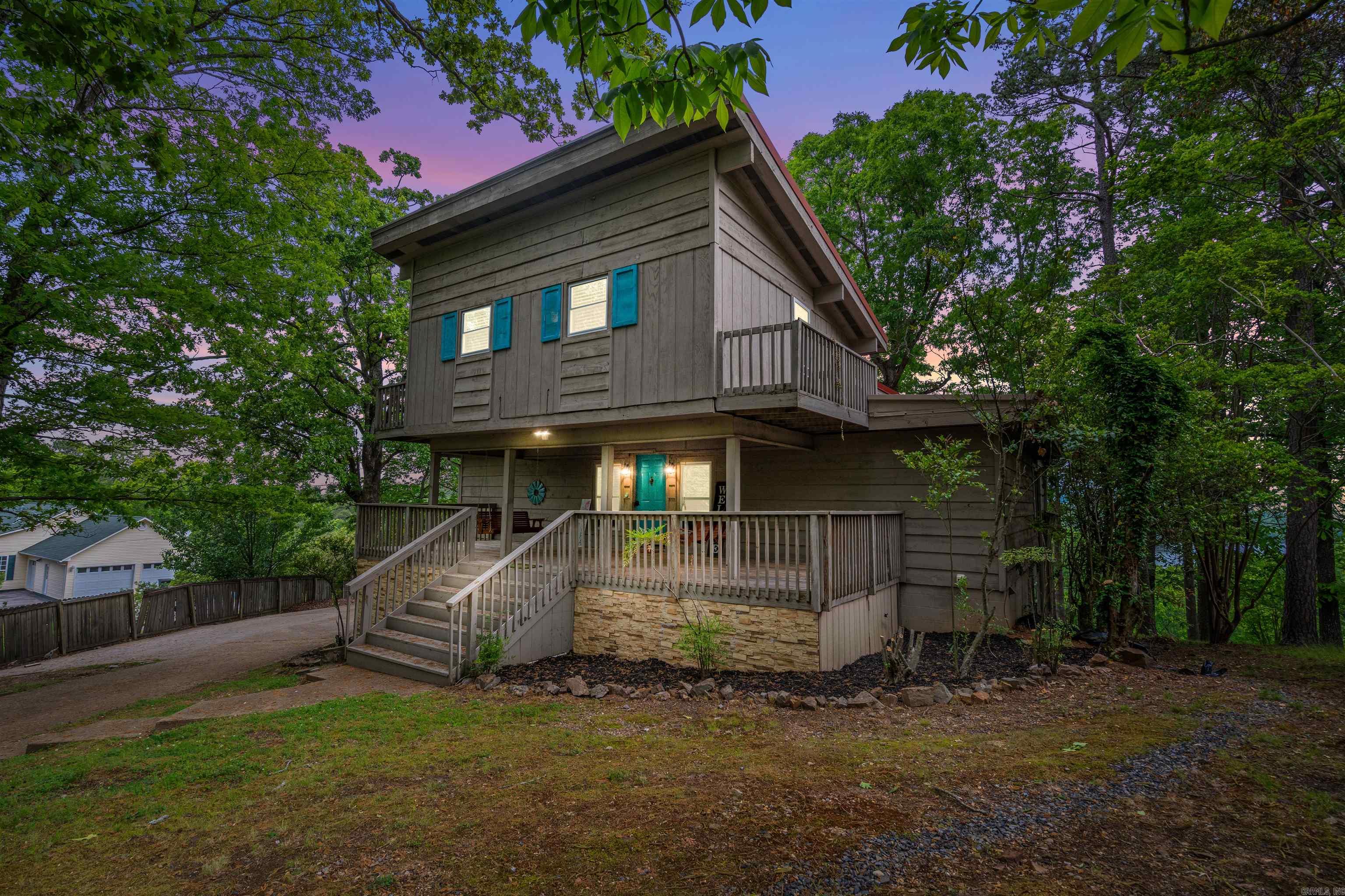Wake up to stunning water views and a lush, private landscape in this spacious 5-bedroom, 4-bathroom home. With soaring vaulted ceilings and expansive windows, the interior is bright, open, and built for both comfort and entertaining. This beautiful home is adorned with updates including bathroom vanities and tile, wood floors upstairs, light fixtures, front porch swings, and more. Unwind in the brand-new hot tub while soaking in panoramic views of the lake and mountains. Whether you're hosting or relaxing, the outdoor setting is unbeatable. Enjoy top-tier amenities including access to a golf course, lake, community pool, and playground—everything you need for resort-style living. This home offers the perfect blend of peace, space, and recreation.