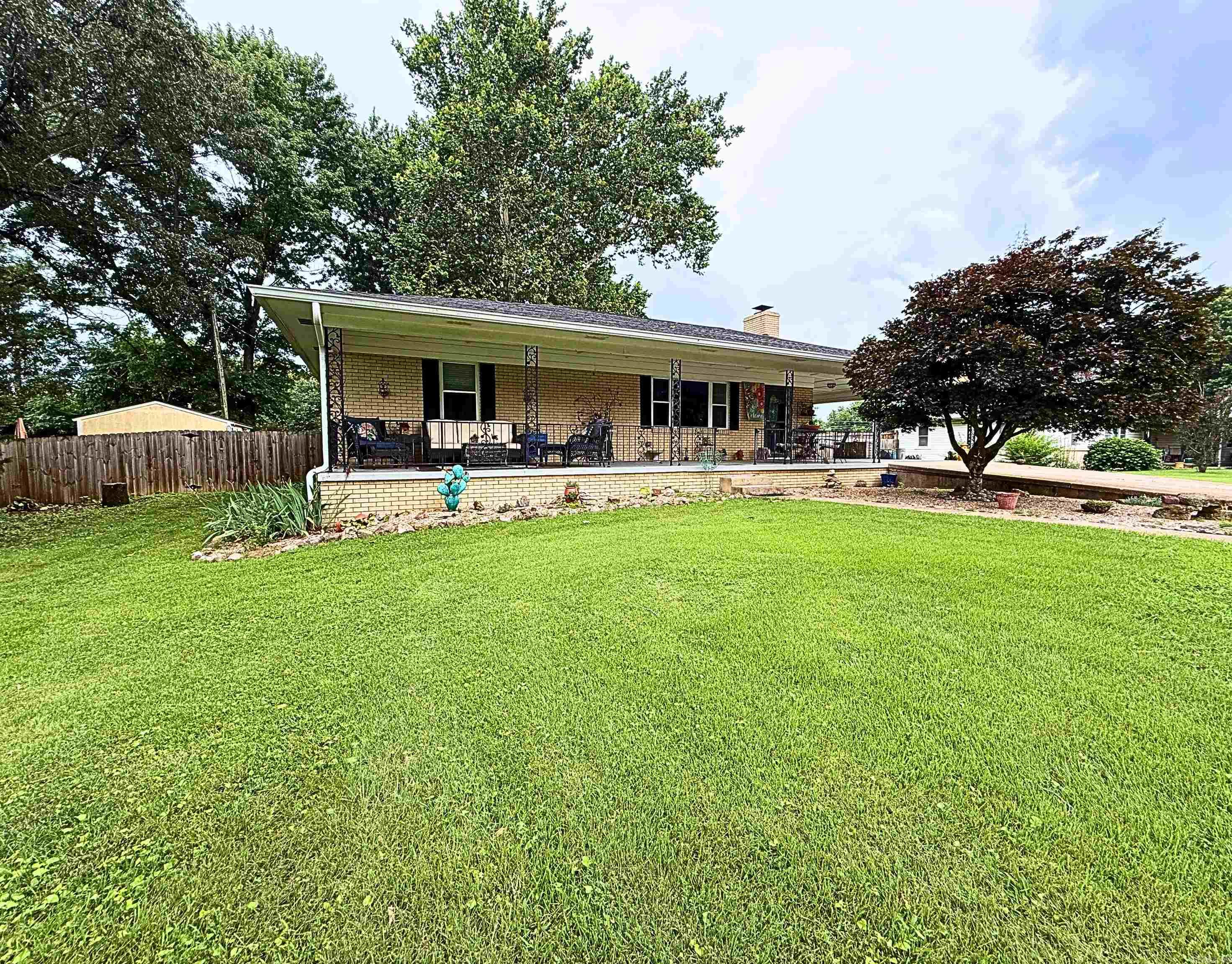 Charming and updated home on half an acre! Conveniently located in town but technically situated in the county, this well-maintained 3BD 1.5BTH home oUers both comfort and practicality. The spacious .51 acre lot features a beautifully landscaped rock garden with sage, lemon balm, naked ladies, etc. Plus a fully fenced backyard with a hardwired hot tub-perfect for relaxing or entertaining! Inside, you’ll find updated flooring throughout the kitchen, dining room, and half bath, along with marble vanity tops in both bathrooms.Living room and hallway consists of original hardwood floors. A new hot water heater installed 2024, and back porch received a new metal roof in 2023. The septic system was pumped and had a new lift pump installed in 2024. Enjoy the benefits of an existing American Home Shield warranty that will transfer to the new owners! Additional perks include electric in both backyard sheds and a basement with potential to add TWO more bedrooms