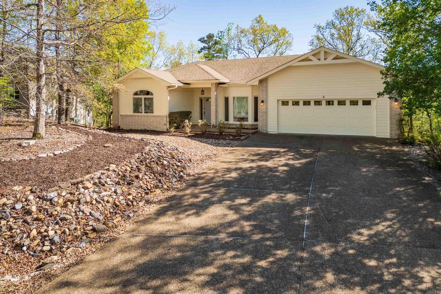 Enjoy golf course living in this 3 bed, 2 bath home situated on Hole #5 of Magellan Golf Course in Hot Springs Village. The back of the home is designed to take in the view, with a spacious sunroom and large windows that bring in natural light and showcase the course.  Inside, you’ll find a comfortable layout with a separate dining room and an open flow into the main living area, centered around a gas fireplace. The kitchen features granite countertops, ample cabinetry, and a functional setup for everyday living or entertaining.  The primary suite offers a walk-in closet and private bath, while two additional bedrooms provide flexibility for guests or office space. Additional highlights include a two-car garage, dedicated laundry room, and thoughtful storage throughout.  Located just 5 minutes from Balboa Beach and close to all of Hot Springs Village amenities, this home offers the perfect combination of scenery, comfort, and convenience.  SEE AGENT REMARKS