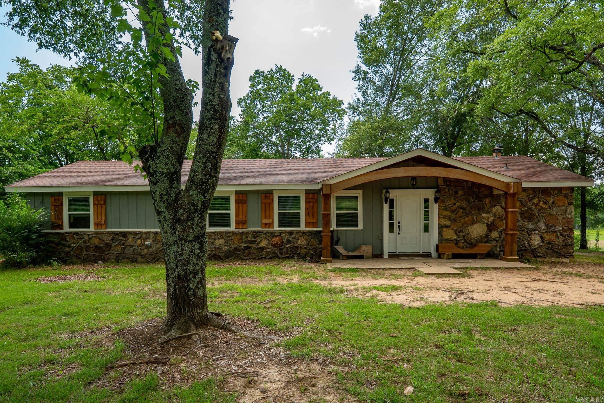 Welcome to this beautiful remodeled 3 bed, 2 bath home with dedicated office space. Perfectly situated on 2 peaceful acres-not in a subdivision. This 1600 sq ft gem combines rustic charm with modern updates and is move in ready. Step inside to discover stunning wood accents, white ship-lap walls and rich laminate flooring. The open concept kitchen is a chef's dream with its butcher block countertops, white cabinetry, subway tile backsplash and a custom range hood. Additional features: office/workout space, built-in shelving and a welcoming entry-way with detail mill work. Outside, enjoy a large barn, fenced dog pen and plenty of room for anything you desire. This home offers country living with modern flair and wont last long! *roof, A/C and flooring were all replaced approx. 8 years ago