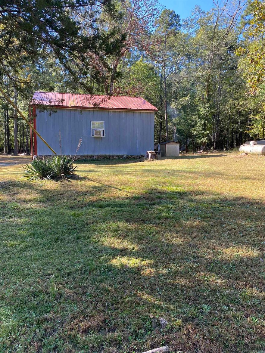 Wow! Here’s the perfect hunting retreat, or peaceful family getaway. This 11 acres has its own trails to explore, or go a few feet into thousands of miles of National Forest on the Oklahoma side that borders the West side of the property.Take the trails to Walnut Mountain or Cow Mountain, or follow Slate Creek to explore nature at it’s best, including plentiful wildlife everywhere to experience. Back at camp you have 2 RV hookups, a well built cabin complete with insulation in the walls,floor and ceiling, finished inside and is ready to be built on to if you desire. Stable your horses in the insulated barn with 2 stalls, or exercise them in the corral or round pen. Your outside wash house comes complete with a washer and  dryer.There’s unlimited clean water from your own well to each building and RV sites, electricity supplied by Rich Mountain Electric. Don’t miss out on this natural retreat!