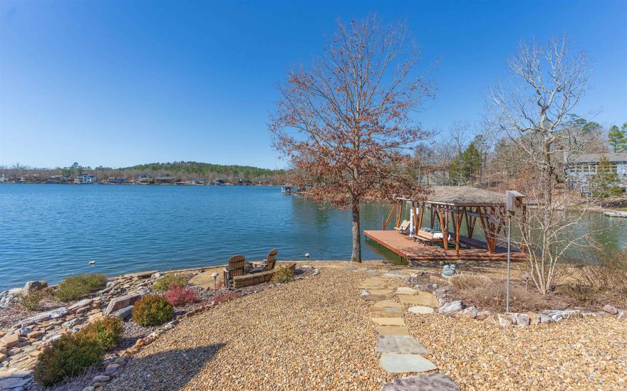 LAKE BALBOA waterfront, custom built, one-owner home with circular drive! You'll love the water view as you walk into the living room with volume ceilings! Kitchen has lake-view breakfast area, pantry, and granite counter tops! Spacious covered and uncovered, composite deck overlooking the lake! Very comfortable split floor plan with separate dining room! Main bedroom with water views, private deck, and sitting area. Main bathroom with walk-in shower, separate tub, and walk-in closet. Guest room/library has dual sided gas fireplace with living room. Lower level features 2 guest rooms (one with murphy bed) full bath, kitchenette and den.  Brand new Lennox dual zoned heat pump. Spacious encapsulated crawlspace with decked storage area. Central vac system and UV filtering custom blinds to enhance view but protect from the sun and Phantom screen doors on all doors. You really don't want to miss this gem! Hot tub/cover conveys with the home! Freshly painted EIFS in 2022 and interior in 2021. Fabulous composite boat dock with lift and swim dock! Fully landscaped, maintenance friendly lot including waterfall, fire pit area, 3-zone irrigation system, and seawall.