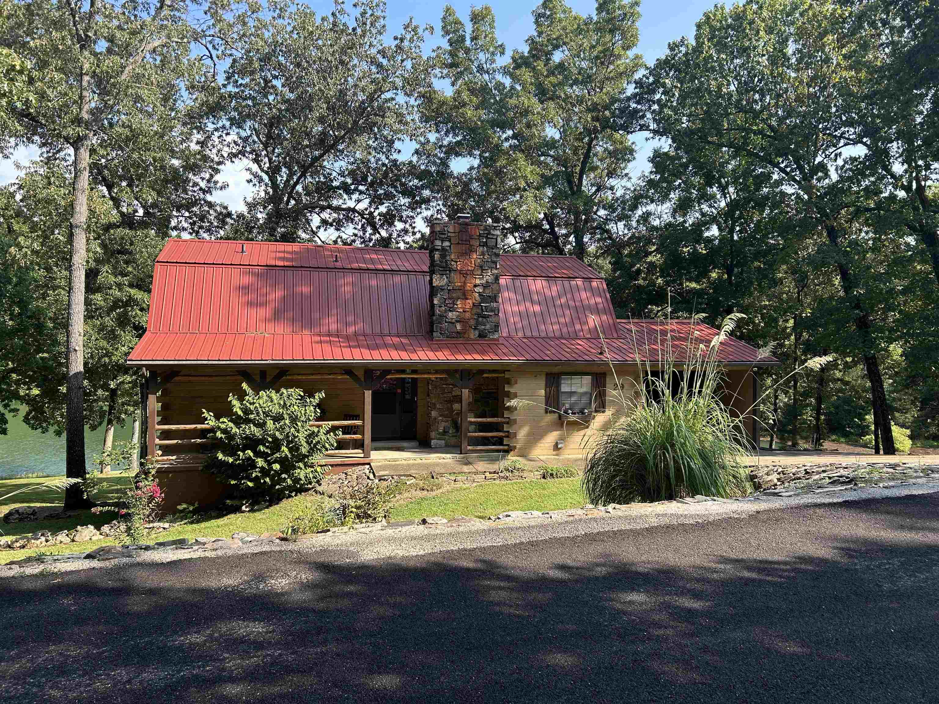 Sitting on 5 lots and nestled into the wooded area with over 350 feet of shoreline on beautiful Lake Aztec your escape awaits! This 3 bedroom 2 bath log home is a one of a kind. Updated with new flooring and lighting throughout, new countertops in the kitchen and new HVAC this one is ready for living & entertaining. Enjoy the 2 large decks one covered one open, a dock with a slide and a great water side shed to house all your lake toys. The main level boasts a beautiful master suite, guest bath laundry & pantry room and the upstairs has 2 nice size bedrooms roomy closets and an additional new bathroom. The gently sloping back yard has room to play and gather. A very popular nightly rental. Call today to take a look at this one of a kind get away! Perfect to make your home or vacation stay.