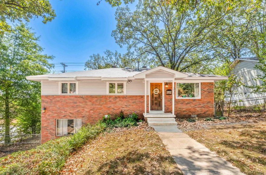 Welcome to this charming North Little Rock home on a corner lot! Enjoy the open floor plan with a spacious kitchen, living, and dining area. Step through French doors to a deck, extending your indoor living space. The kitchen features granite countertops, a gas cooktop range on the island, a modern vent-hood, and stainless steel appliances. Dark hardwood floors throughout add elegance. Two bedrooms on the main level and two on the lower level provide ample space. Updated bathrooms & Kitchen.  The fully fenced backyard is perfect for relaxation and you will love the double side gate.  Conveniently located near amenities. New roof (2018), HVAC condenser (2018), and dishwasher (2021). Recently updated deck flooring and rails. Make this enchanting NLR home yours and embrace the lifestyle you've always dreamed of. Welcome home!
