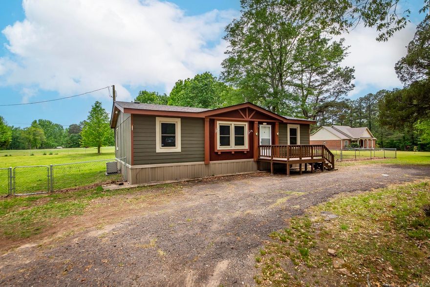 BRAND NEW ROOF!! Charming Mobile Home on a Private Acre -- close to town and within a mile from Eastside Elementary School. Nestled on a full acre of peaceful, tree-lined land, this adorable mobile home offers the perfect blend of privacy and convenience. Whether you're starting out, downsizing, or just looking for a quiet retreat, this property checks all the boxes! Step inside to a warm and inviting living space with plenty of natural light, a functional layout, and cozy charm throughout. This home has been freshly painted throughout and includes 3 bedrooms, 2 bathrooms, along with a well-equipped kitchen and a comfortable living area for relaxing or entertaining. Outside, enjoy the beauty of your own fully fenced, private acre -- ideal for gardening, outdoor gatherings, or simply soaking in the tranquility. Affordable, Adorable, updated, and MOVE IN READY - Don't miss this rare opportunity to own your slice of country style living with in town convenience. Prices like this for a 3 bedroom move in ready home in the Cabot Schools are hard to come by!