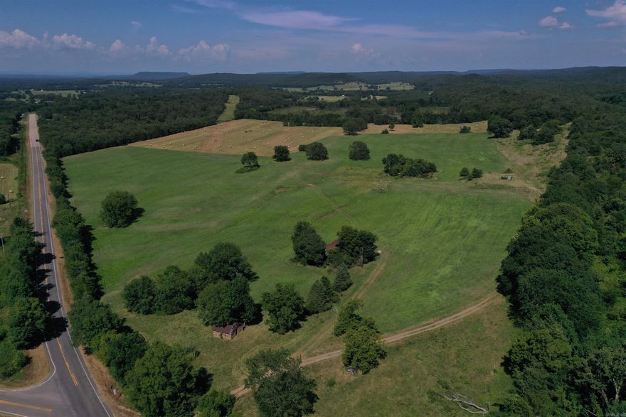 Located conveniently just north of Booneville, AR, with frontage on Highway 23 and Highway 41, this 203 +/- Acre farm would be a great fit for many operations. The farm is nearly all productive pasture, with strips of trees and old growth timber dotting the landscape. The land is fenced, with cross fencing in places. Although it is currently being used for hay production across all of its acres, this would make a great cattle farm as well, with ponds for water and great shade. The topography on this property is very mild, making it great for farming and hay production, but also a prime location for Poultry houses. There is an older fixer upper home on the property, as well as an antique log cabin that will be a great conversation piece for years to come.  ⢠203 +/- Acres ⢠Fenced Pasture ⢠Older fixer upper home ⢠Very unique antique log cabin ⢠Road frontage on HWY 23 and HWY 41 ⢠Frontage on Nubbin Ridge Rd ⢠Currently used for Hay production ⢠Good location for Poultry houses ⢠Power and water available ⢠Natural Gas available ⢠Multiple build sites ⢠Great access ⢠Deer Hunting ⢠Multiple ponds ⢠10 minutes from Booneville ⢠10 minutes from Charleston ⢠20 minutes from Paris