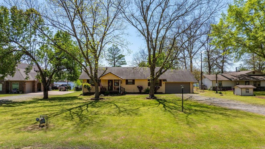 This Old River LAKE FRONTAGE Home with Amazing View on almost half acre is the best place to relax! Sip your morning coffee on the 27x10 Screened-In-Porch, fish from the bank or Launch Your Own Boat! The Lake was formed when the Corps of Engineers re-routed the Arkansas River to form this huge private Lake. So, the fishing here is incredible!!! This peaceful home features extra large room dimensions, and vaulted Living / Kitchen / Dining Rooms all with spectacular lake views! The kitchen is updated w/quartz countertops, gas stove, granite composite sink & a large separate pantry. The Very Spacious Master Bedroom has a large walk in closet & also allows you to wake up looking right at the beautiful water! The Beautiful Main Bath has been remodeled & also allows for someone handicapped.The oversized Guest Room also has its own private half bath! There is a Stackable Washer/Dryer in a Master Bathroom Closet. The garage is mostly insulated, has window AC & a Wonderful Separate walled-off space in back - an 18x8 Workshop or Extra Storage Space. The roof, gutters, HVAC, garage door & septic system have all been replaced in the last 7-9 years. Gas Hot Water Heater was replaced April 2025.