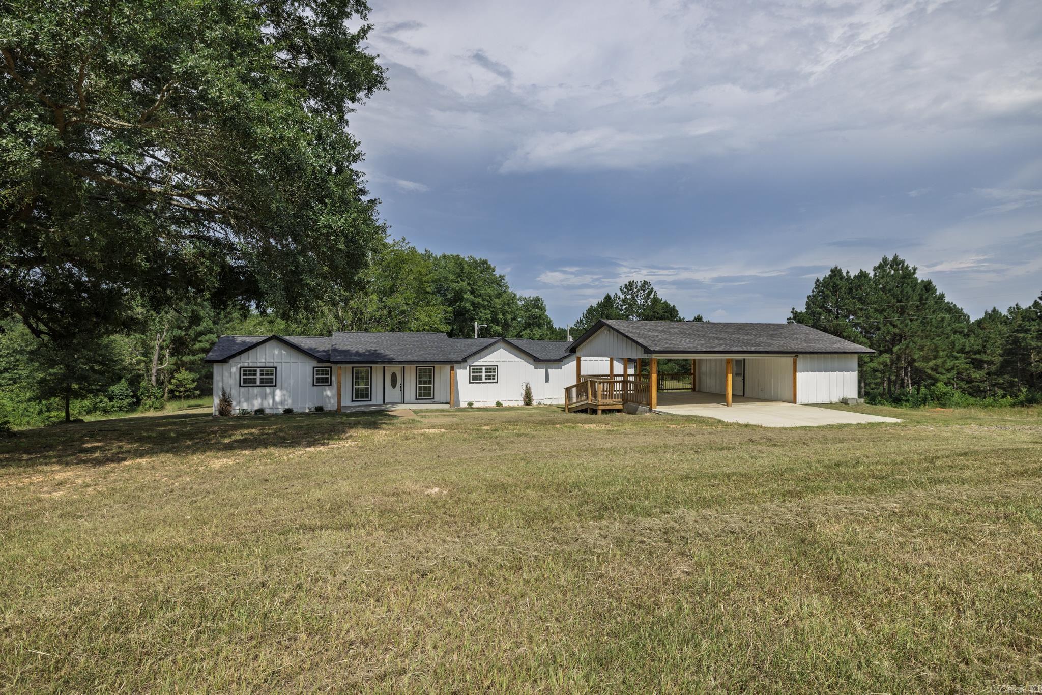 This beautifully renovated 3-bedroom, 3-bath home sits on over 16 acres of serene pastureland, offering breathtaking views and a peaceful, country setting. The open-concept living area is perfect for entertaining, with modern updates throughout. The master suite features a luxurious, oversized walk-in shower and a spacious closet. Enjoy outdoor living on the gorgeous back deck, ideal for relaxing and taking in the scenery. The property also includes a charming carport with an attached workshop, as well as a smaller storage building for added convenience. Located just a short drive from Arkadelphia and I-30, this home offers the perfect blend of country living with easy access to nearby amenities.